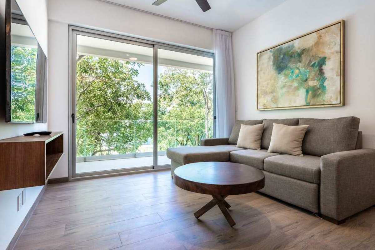 Open living area with sofa and balcony access
