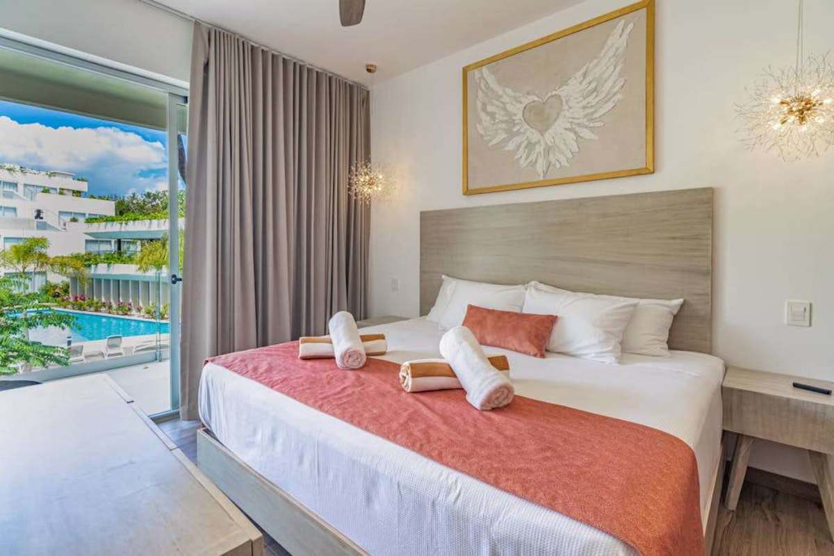 Restful king bedroom with warm terracotta bedding and soft light for a great night's sleep in Playacar
