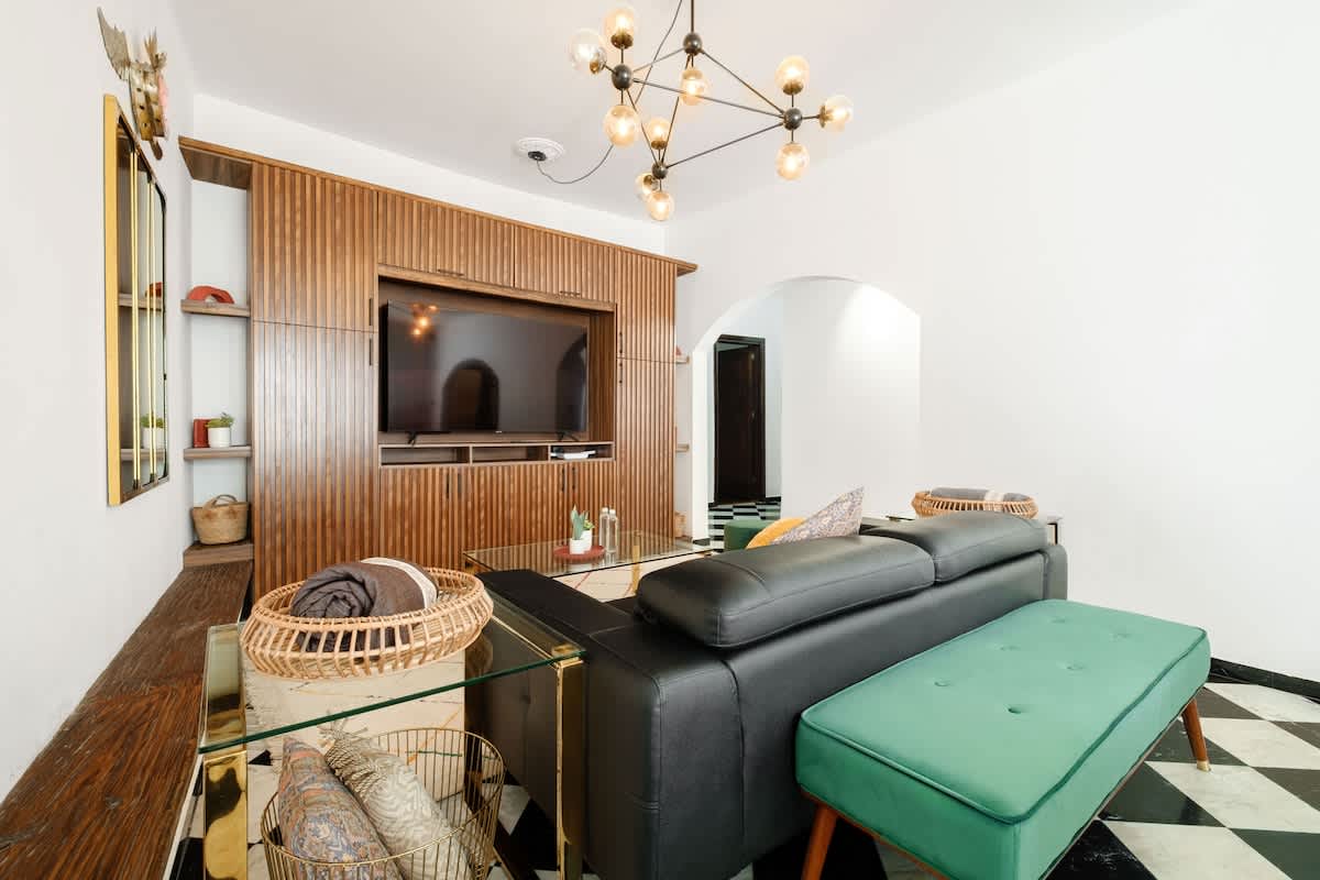 Art deco living room with warm wood paneling and a leather sofa, stylish lounging in the heart of Polanco