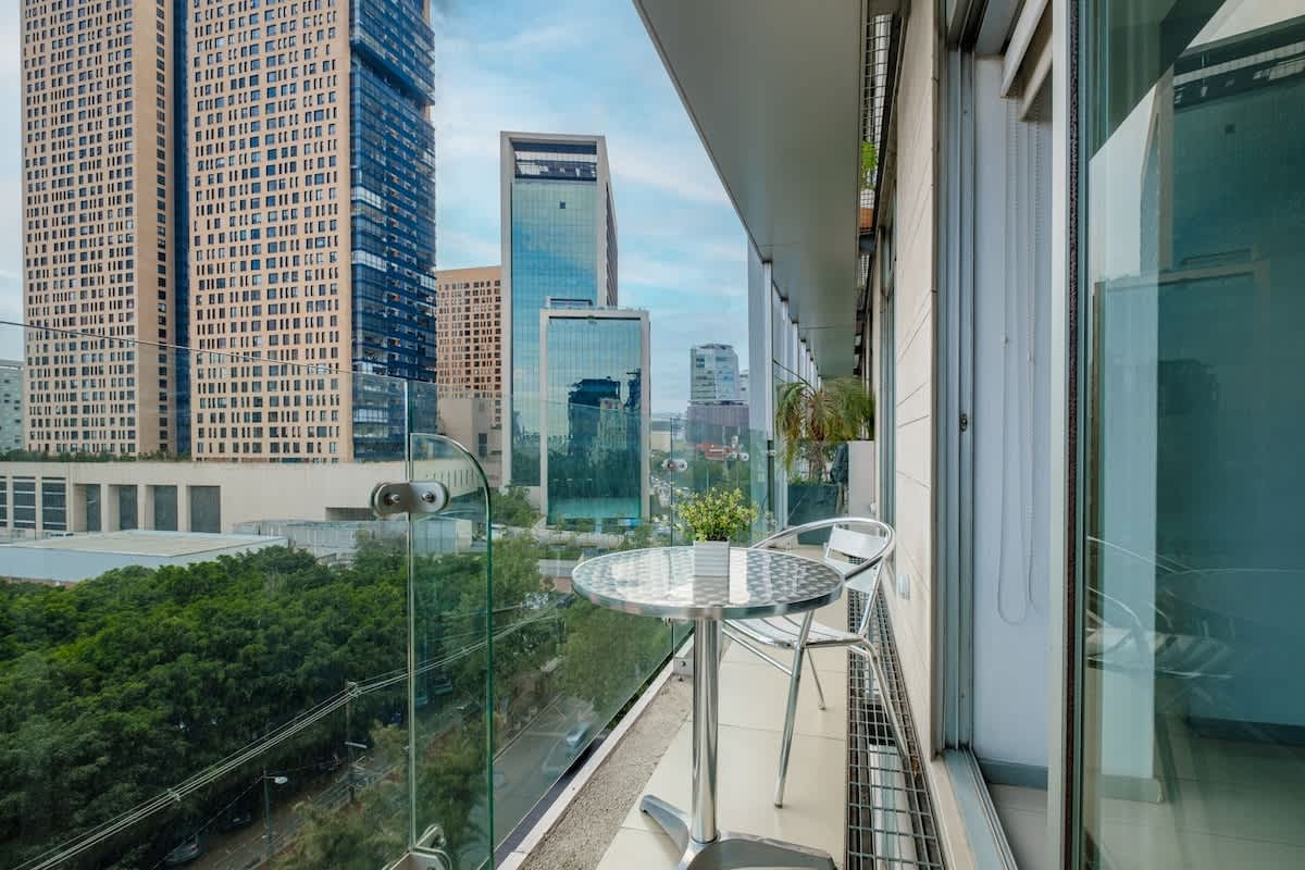 Private balcony with a glass railing and sweeping Polanco skyline, your open-air perch above the city