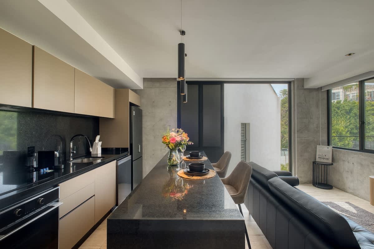 Modern kitchen with a dining counter and full appliances, everything you need for a meal at home