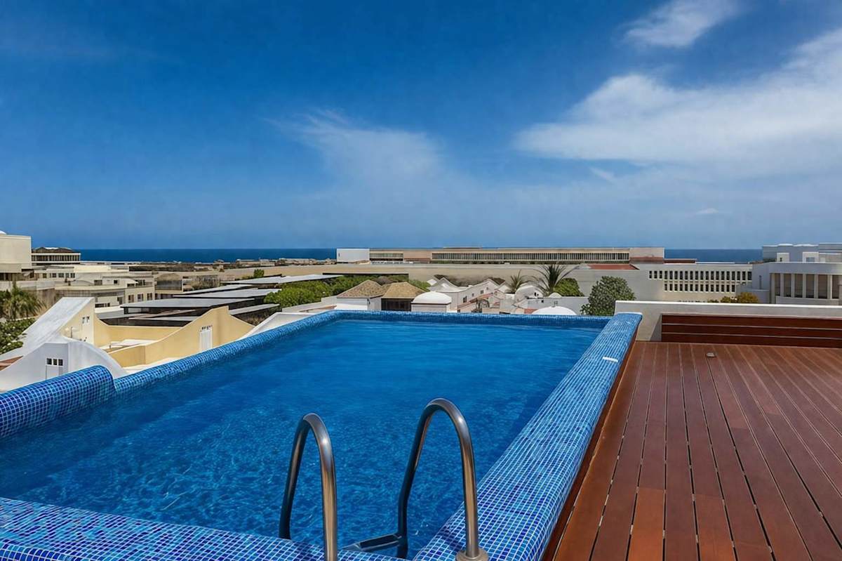 Shared rooftop infinity pool with ocean views
