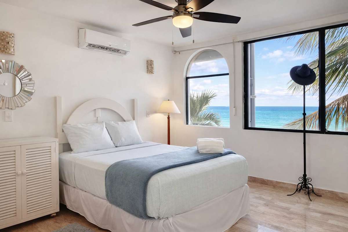 Bedroom with ocean views and a comfortable bed