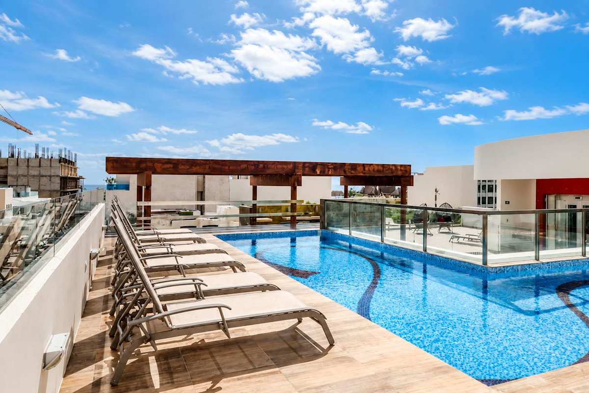 Shared: rooftop pool with sun loungers and ocean views.
