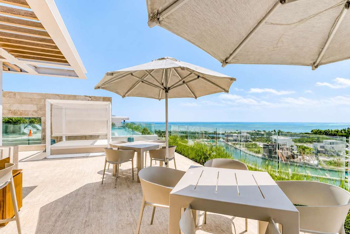 Shared rooftop terrace lounge with marina views