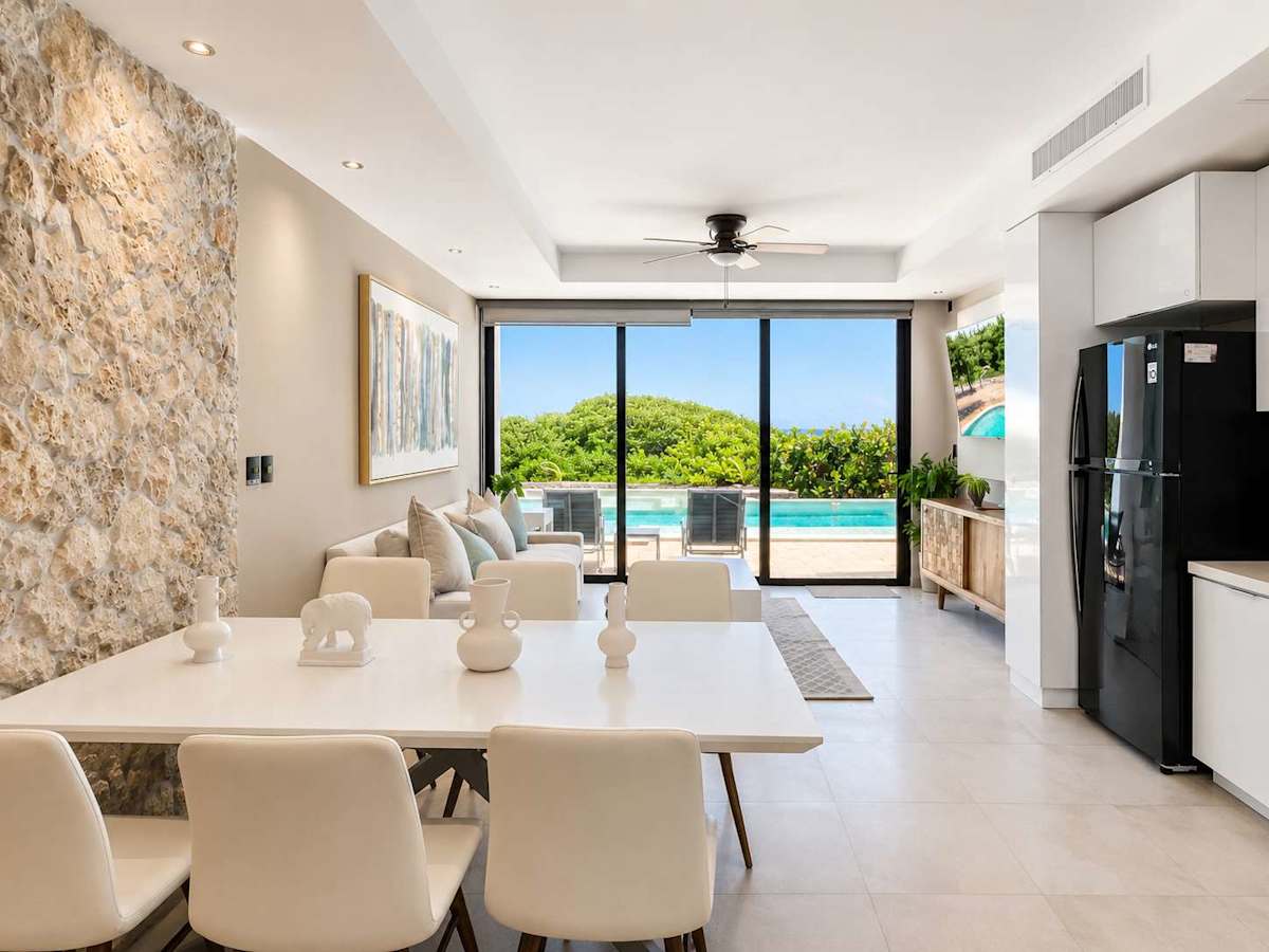 Open living and dining space with ocean view and full kitchen