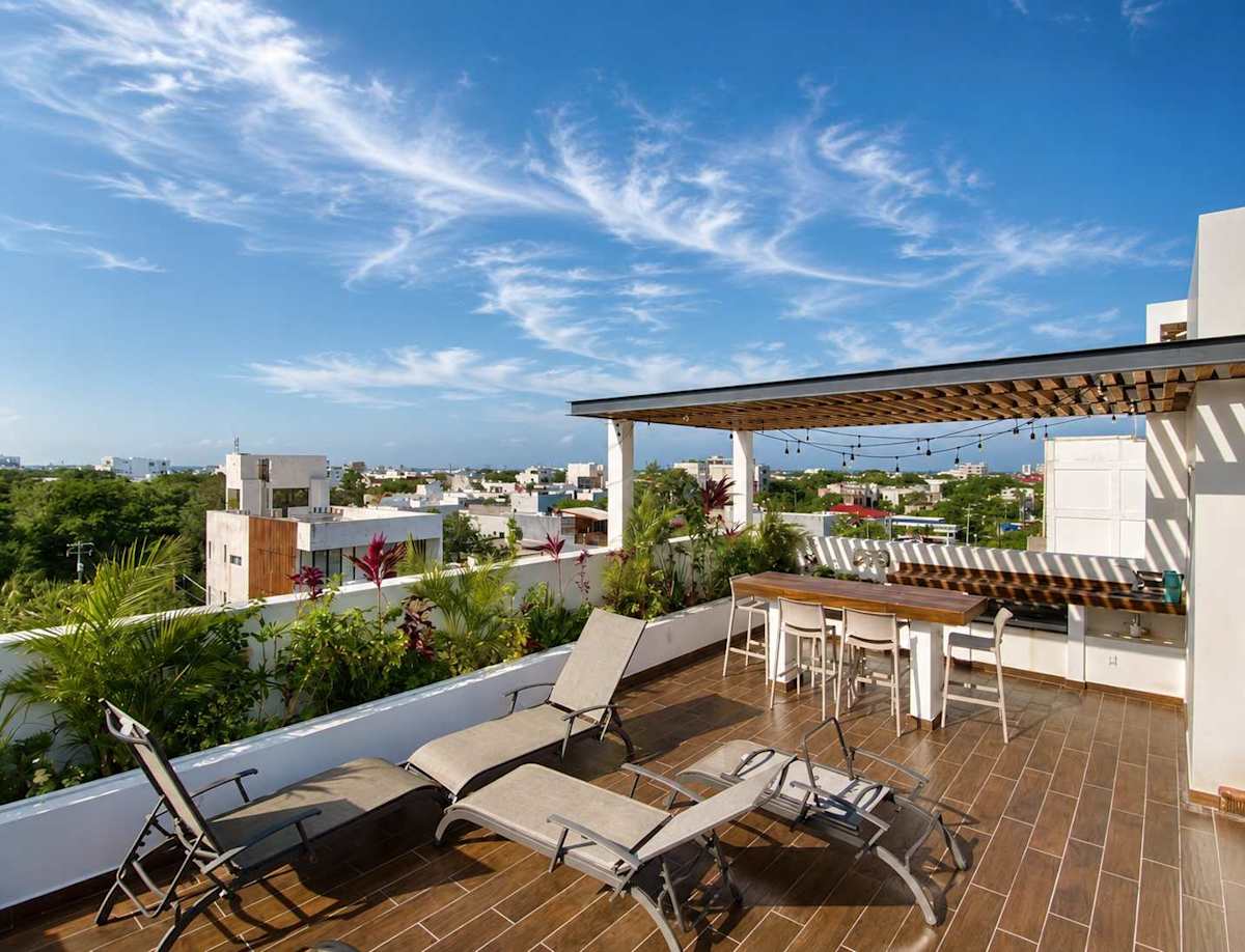 Shared rooftop terrace with sun loungers