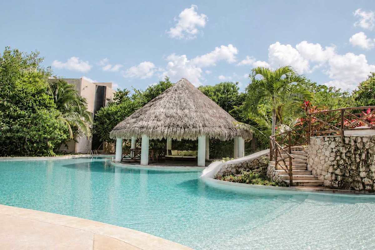 Shared pool with palapa shade and water slide