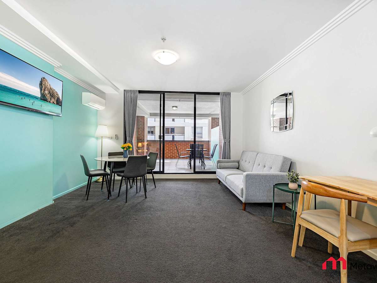 Spacious open-plan studio featuring a sofa bed, work desk, dining table, and access to a private balcony.