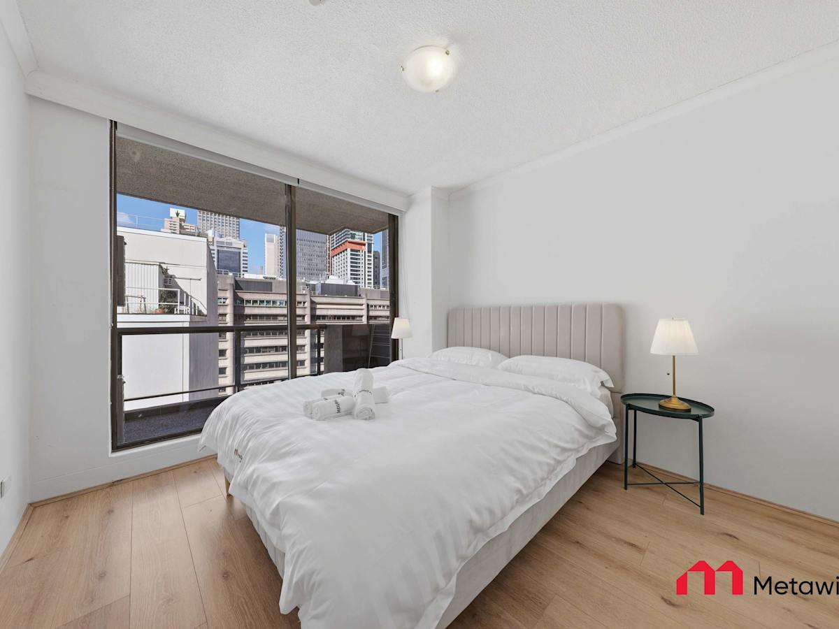 Spacious bedroom with large window views