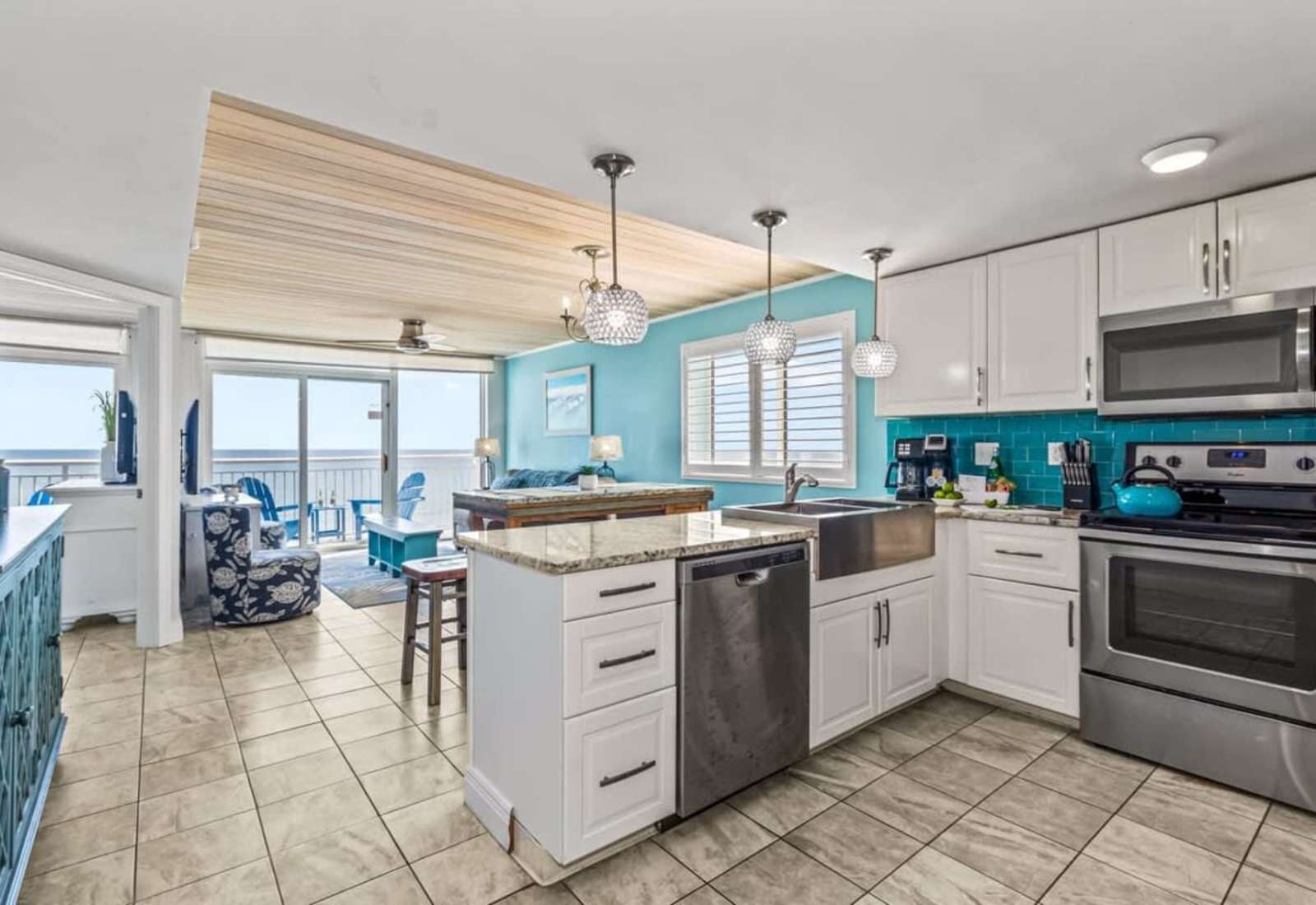 Cook, dine, and relax in this stunning open-concept space featuring a modern kitchen with granite countertops, stainless steel appliances, and vibrant coastal accents. The dining area flows seamlessly to the living room, all with gorgeous ocean views