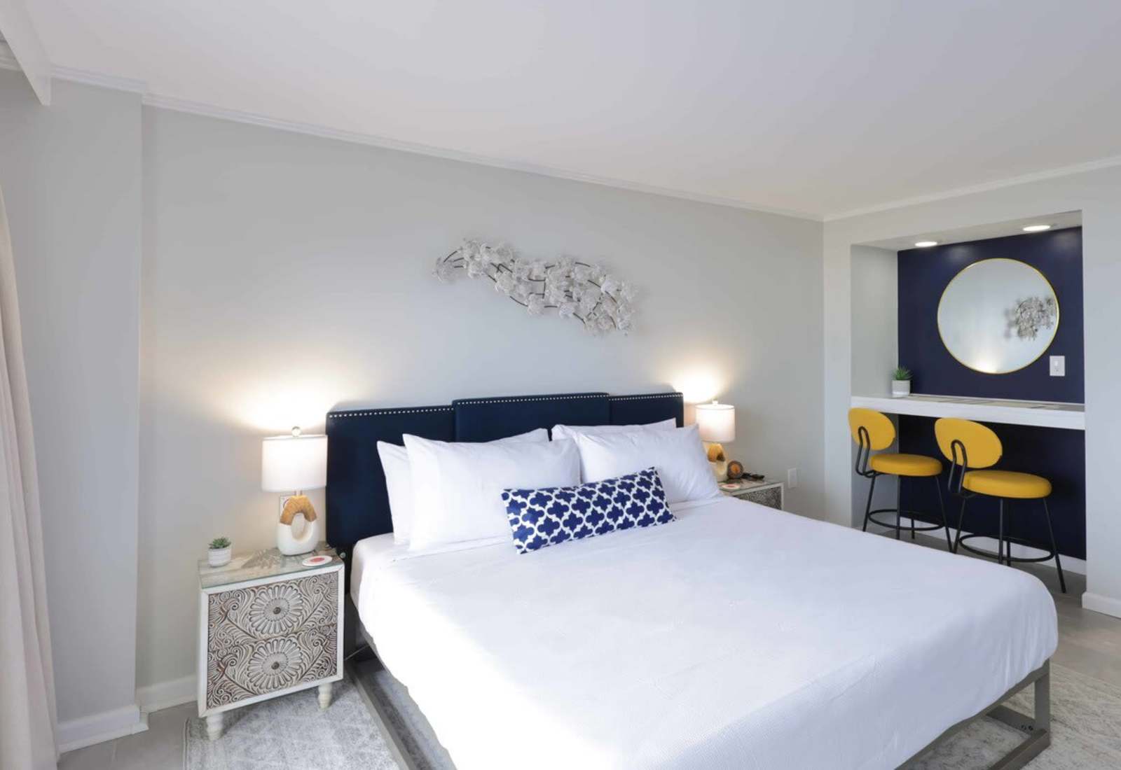 Sleep like royalty in this dreamy king suite—navy velvet headboard, designer touches, and a cozy breakfast nook that says, “Stay in bed a little longer.”