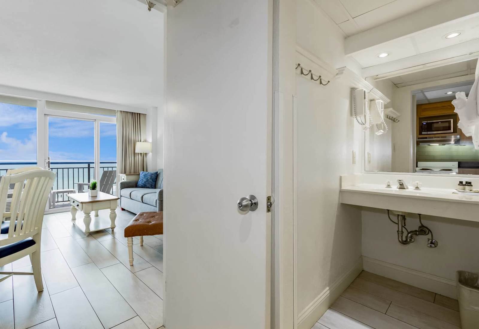 From sunrise reflections in the mirror to sunset views from the sofa—this bright, beachy space connects comfort with coastal charm in all the right ways.