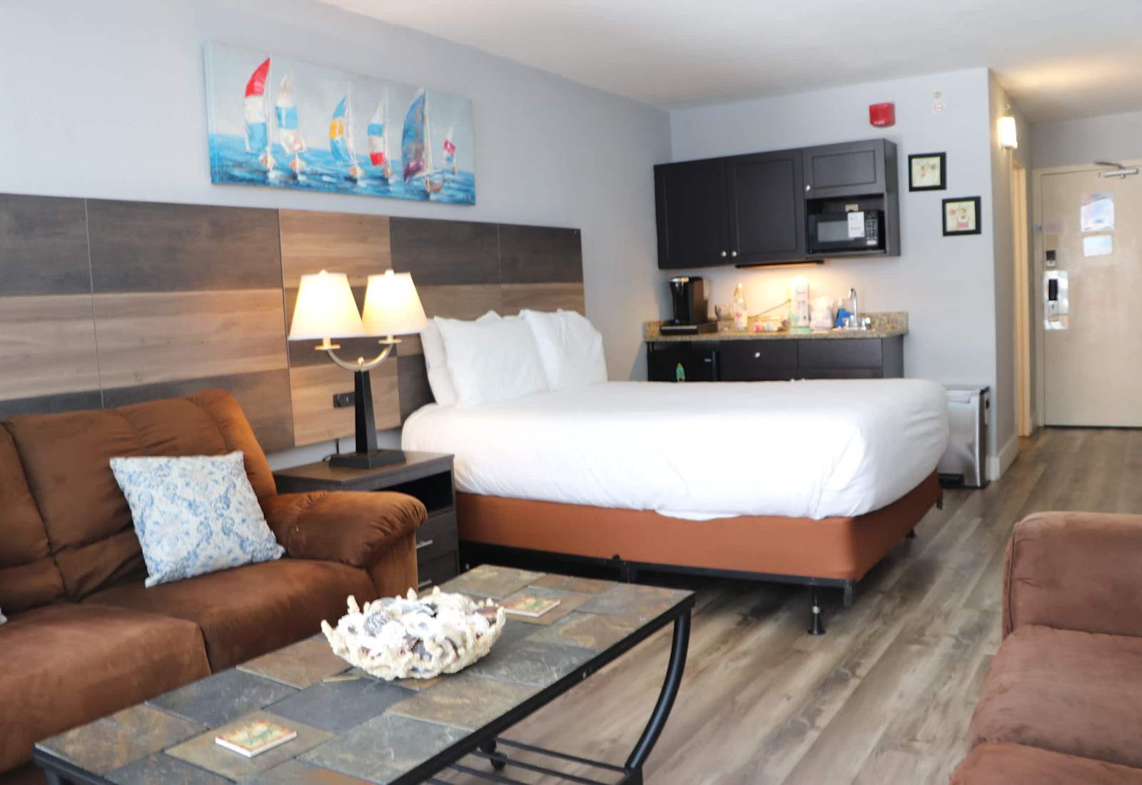 Well-appointed studio accommodation featuring a comfortable bed, kitchenette, dining area, and cozy living space.