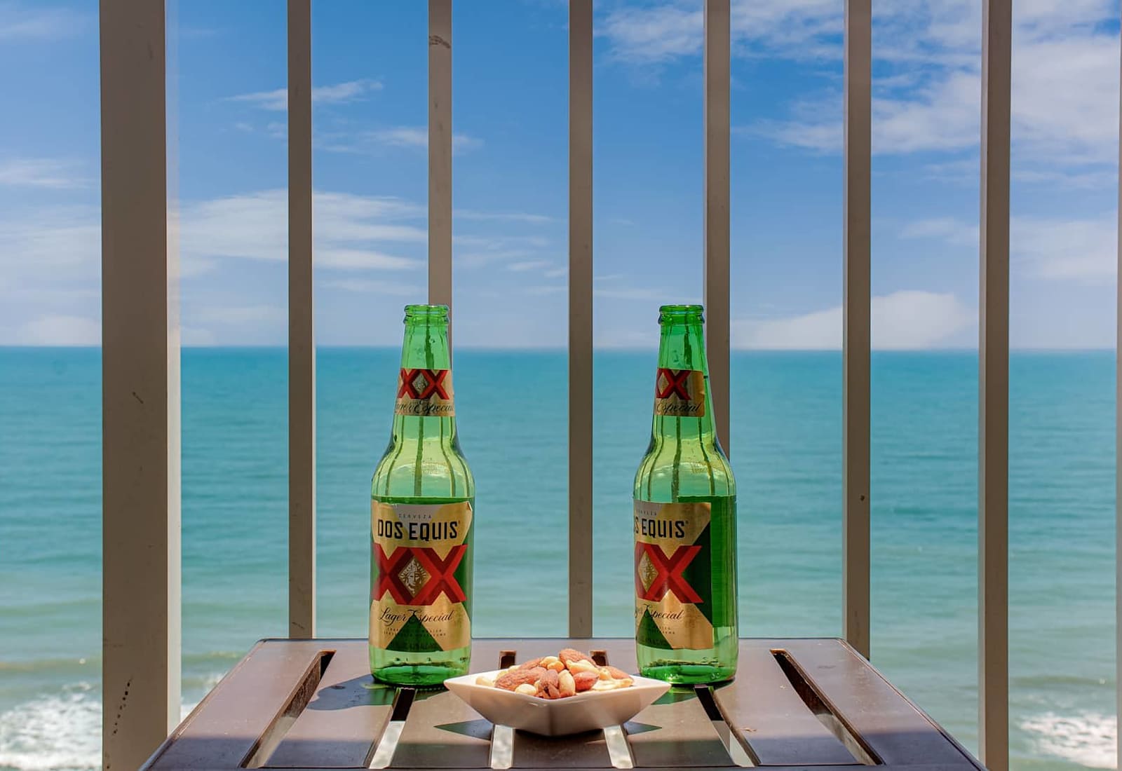Enjoy a refreshing drink on your balcony, overlooking the waves