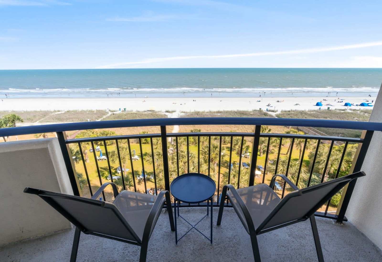 Sip your morning coffee or toast to sunset magic—this private balcony delivers front-row seats to the Atlantic with swaying palms below and salty breezes all around.