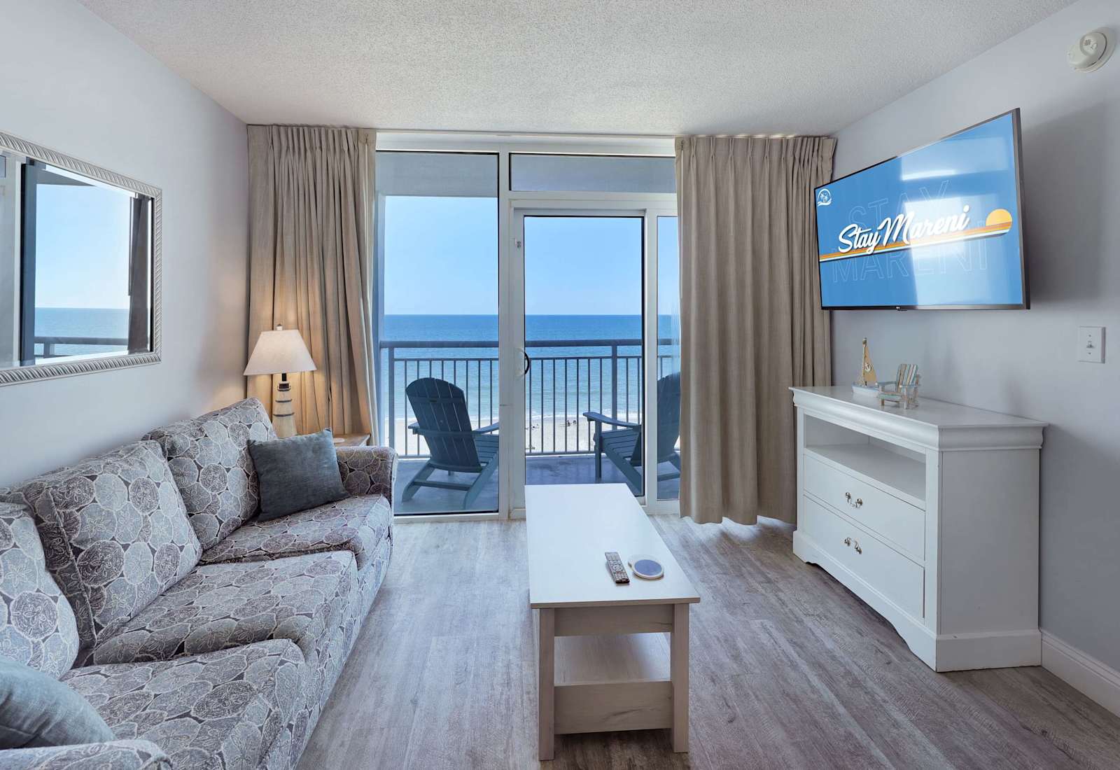 Wake up to panoramic ocean views from your beachfront living room! Relax in comfort with cozy seating, streaming TV, and direct balcony access.