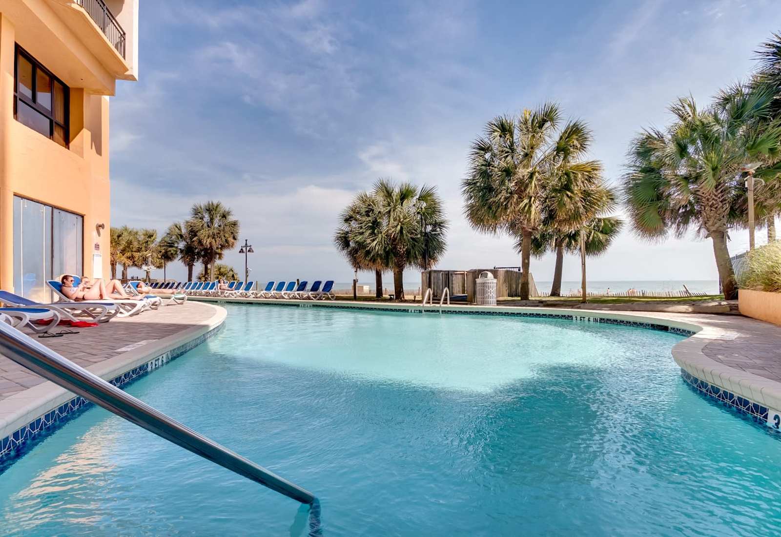 Dive into relaxation at the oceanfront pool, where swaying palms and sea breezes set the scene for the perfect beach day. Lounge, swim, and soak up the sun just steps from the sand.