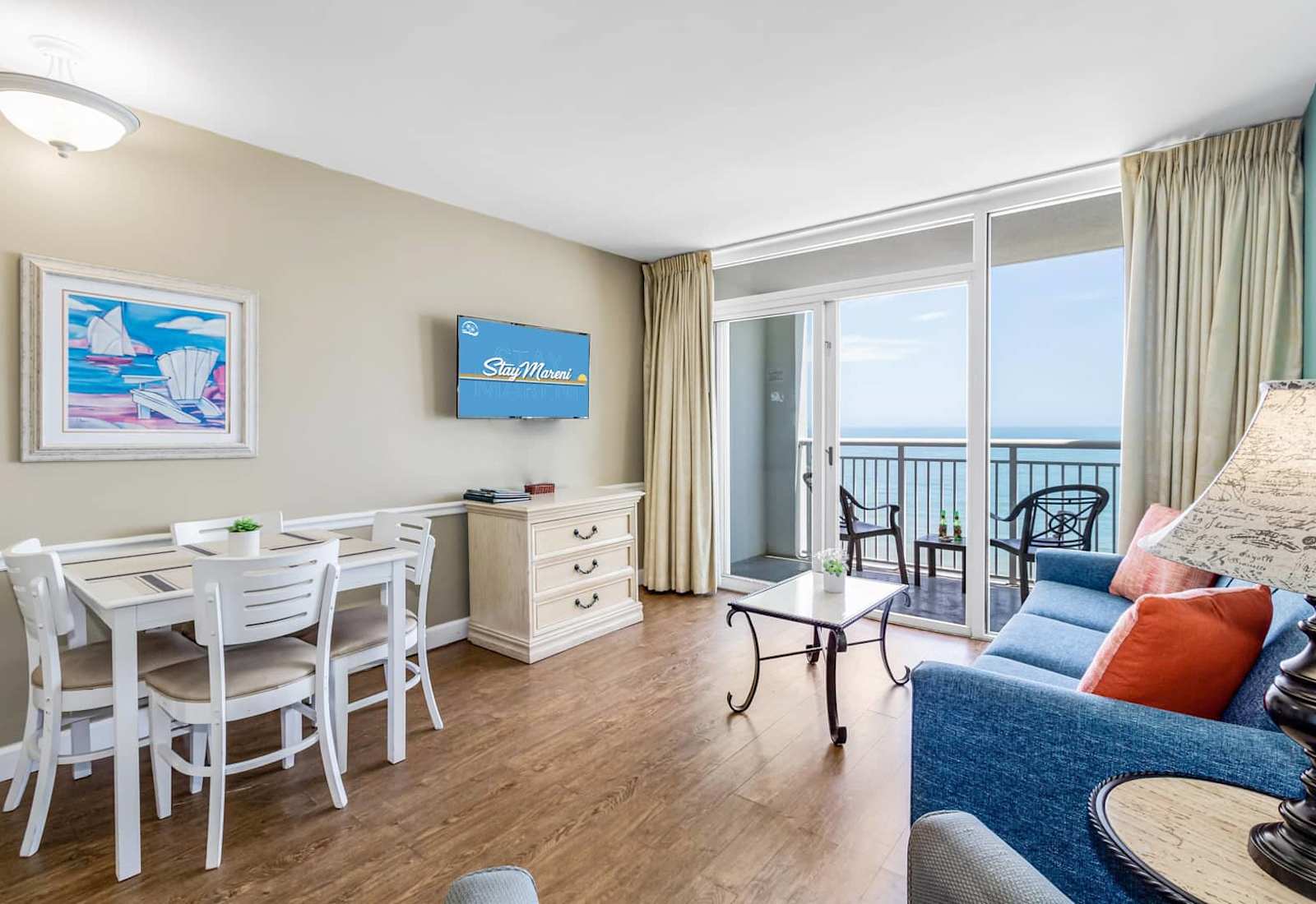 Bask in ocean views from this bright and inviting living space! Featuring a cozy sofa, dining area, and balcony access, it’s perfect for relaxing or enjoying meals with a breathtaking backdrop. Your serene beach retreat awaits!