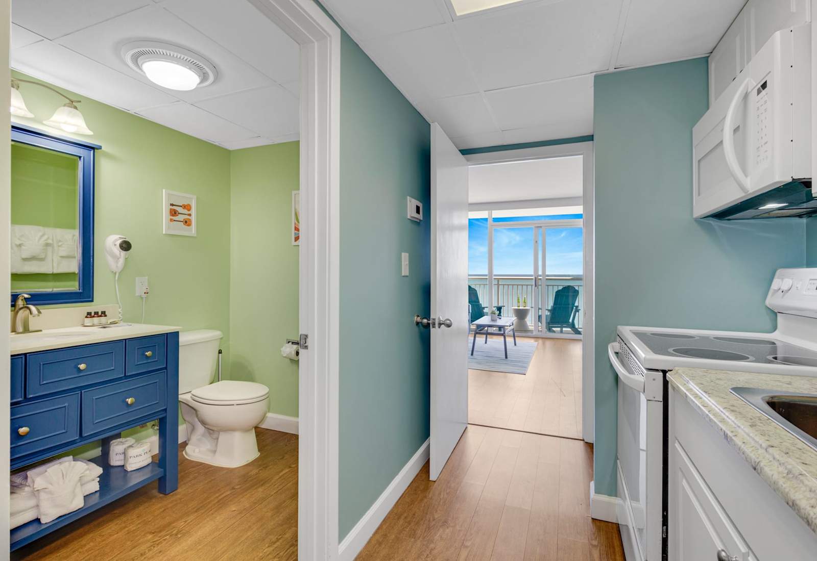 Enjoy a clean and inviting bathroom featuring updated fixtures, gentle lighting, and subtle coastal touches. Nestled between the living room and bedroom, it offers a refreshing retreat after a day at the beach.