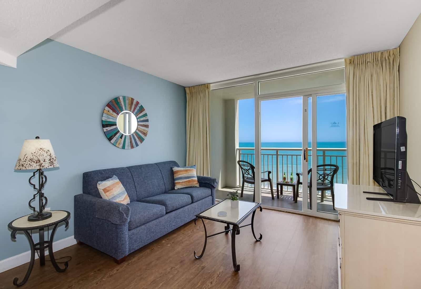 Soak in stunning ocean views from this cozy living space, complete with a comfy sofa, stylish décor, and private balcony access. Relax, recharge, and enjoy the serenity of beachside living.