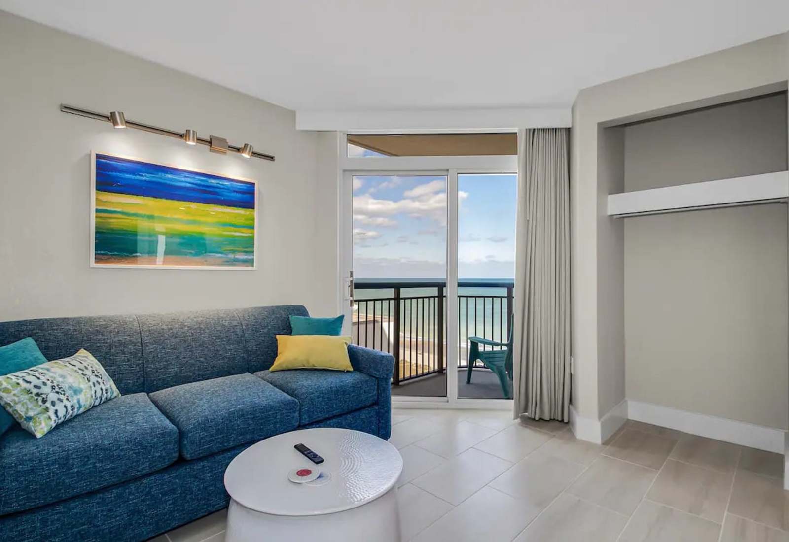 Relax in this cozy, living area featuring a plush sectional, accent lighting, and a Smart TV for entertainment. The soothing decor and comfortable seating make it an ideal spot to unwind after a day of exploring.