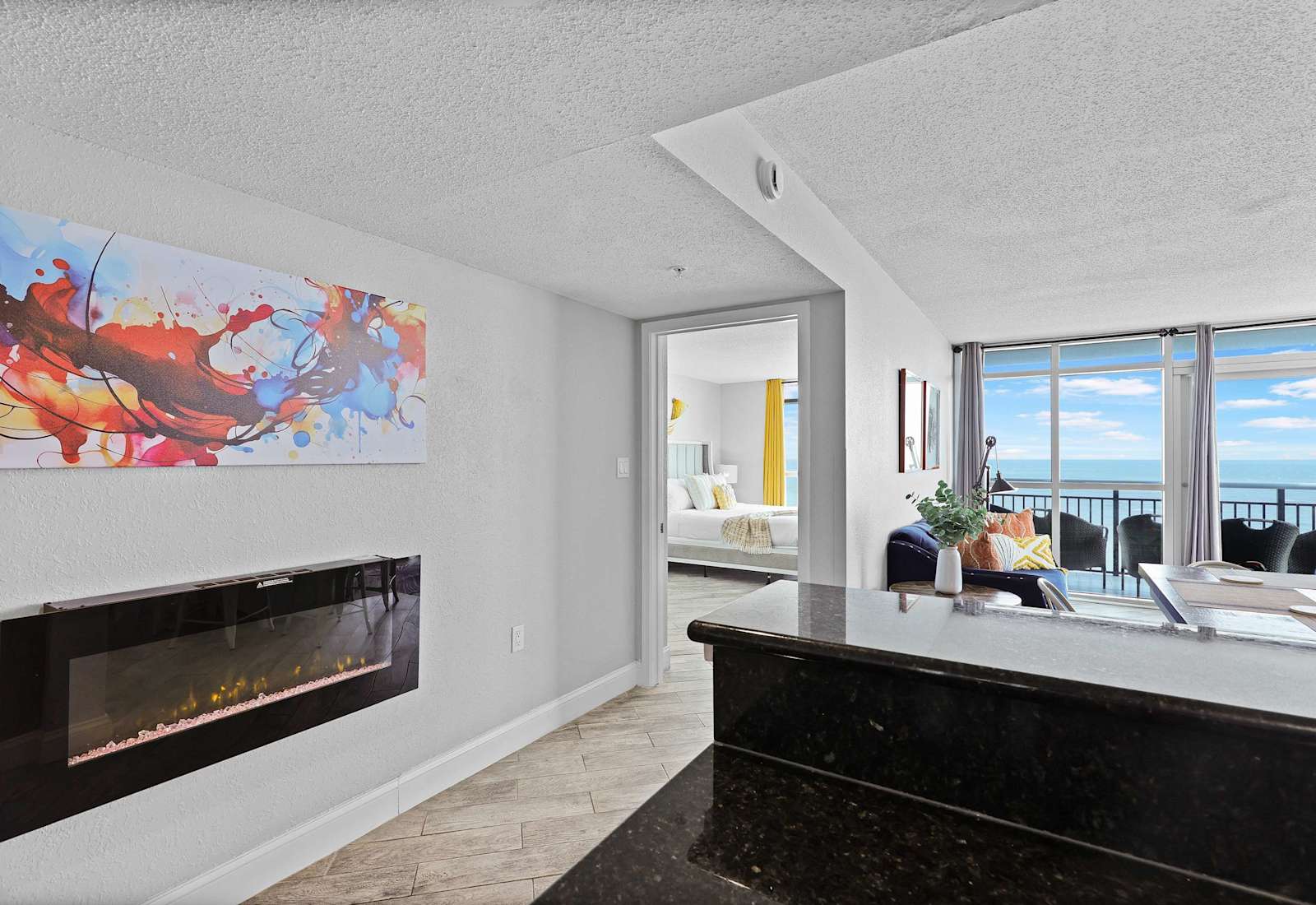 Enjoy cozy vibes and stunning ocean views in this stylish beachfront condo! Featuring a modern electric fireplace, bold artwork, and open layout, it’s the perfect blend of comfort and coastal charm in the heart of Myrtle Beach.