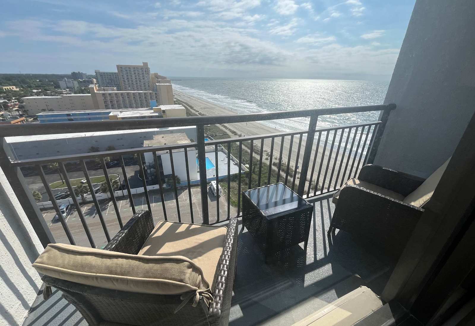 Inviting balcony seating area overlooking the pristine beach coastline and ocean waves