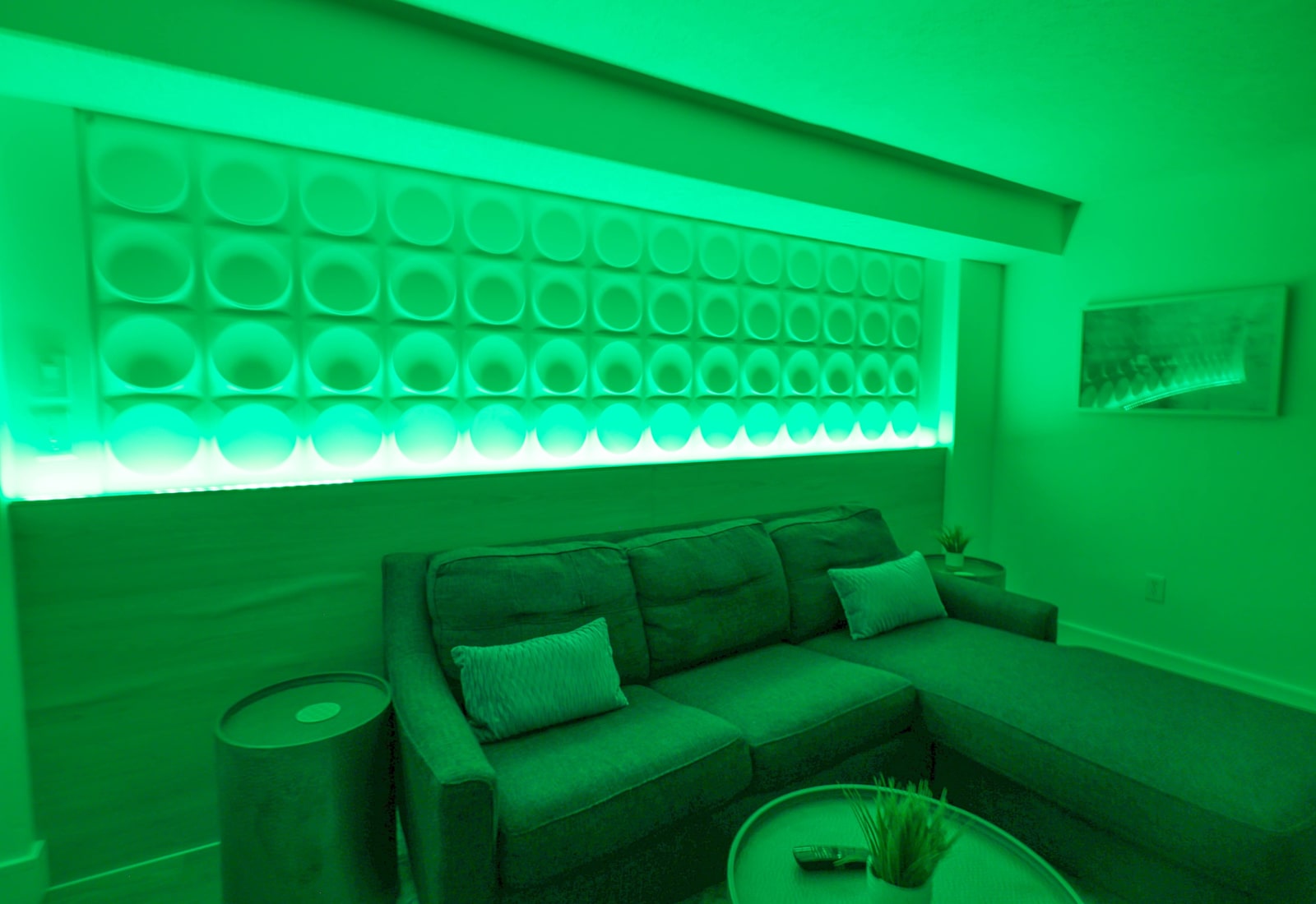 Unwind in this stylish living area with a comfortable sofa, modern accent lighting, and a relaxing lounge atmosphere.