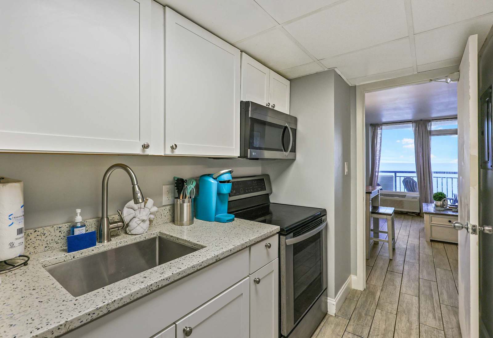 Cook with a view in this fully equipped kitchen featuring modern appliances, granite countertops, and ocean sights just steps away. Perfect for whipping up meals during your Myrtle Beach getaway!