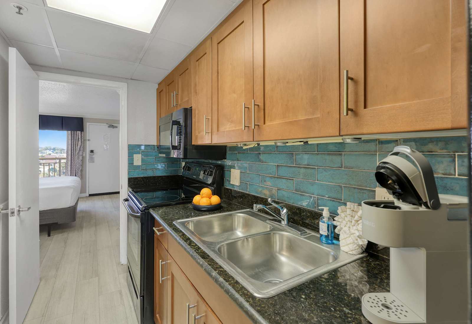 This fully stocked galley kitchen makes vacation cooking easy, with sleek appliances, granite counters, and a coffee maker to kickstart your mornings. Enjoy comfort and convenience just steps from the beach.