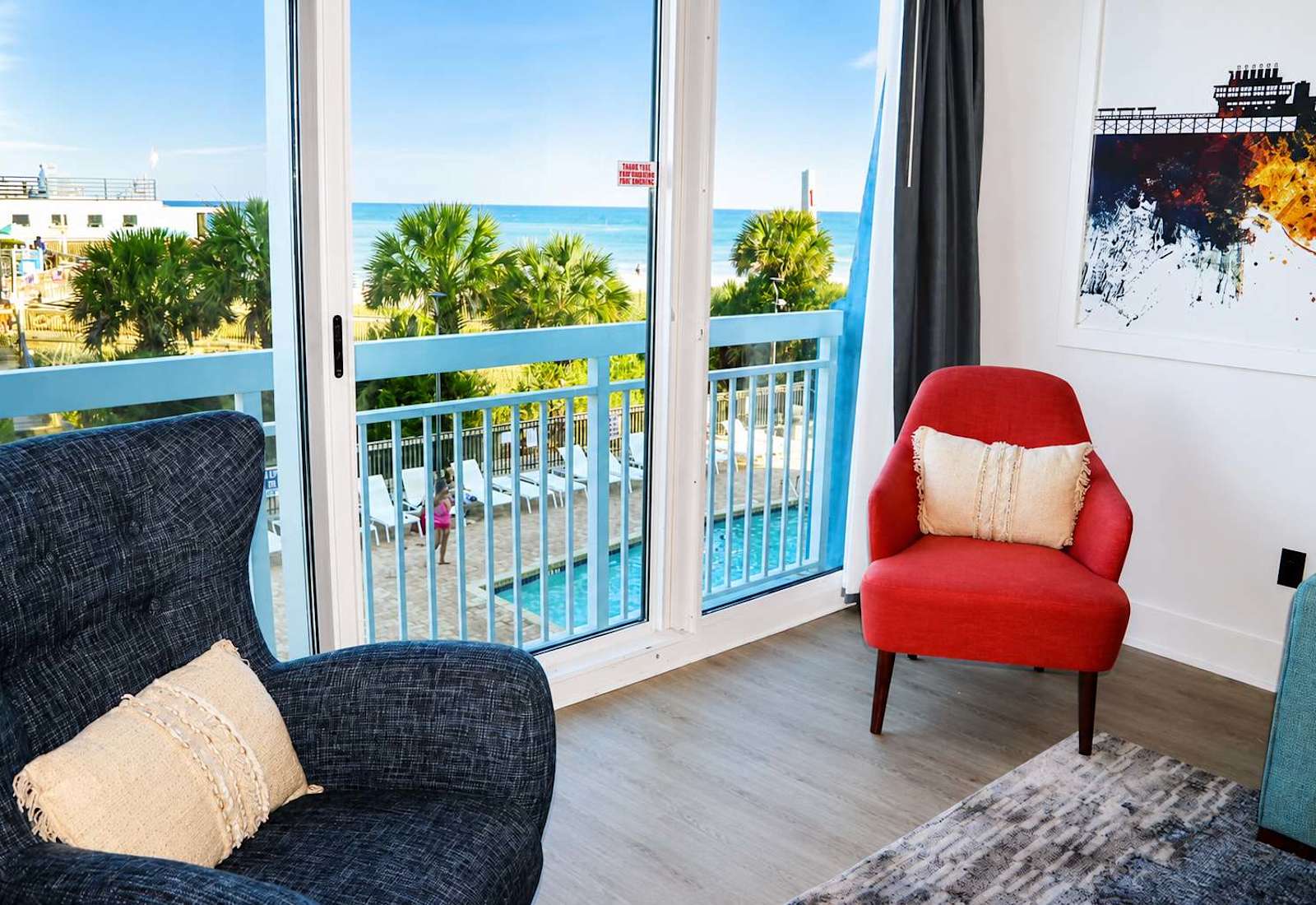Floor-to-ceiling windows frame breathtaking ocean views, filling the space with natural light and giving you a front-row seat to the beach—all from the comfort of your living room!