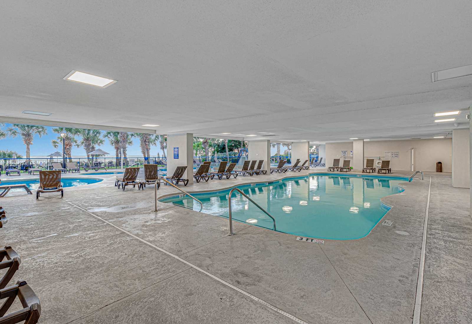 Sunshine or shade, take your pick! Our indoor-outdoor pool lets you lounge in comfort while soaking up views of palm trees and ocean breezes—poolside perfection starts here!