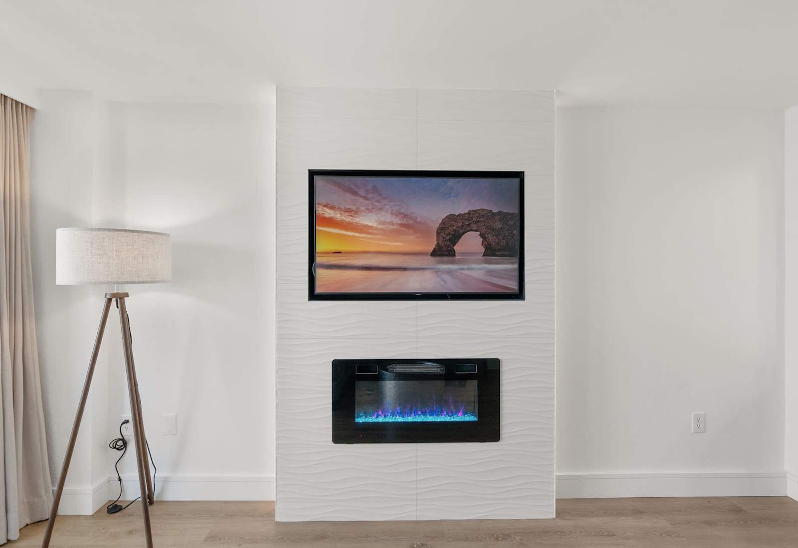 Cozy up by the electric fireplace and enjoy a movie night with stunning ocean views in the background.