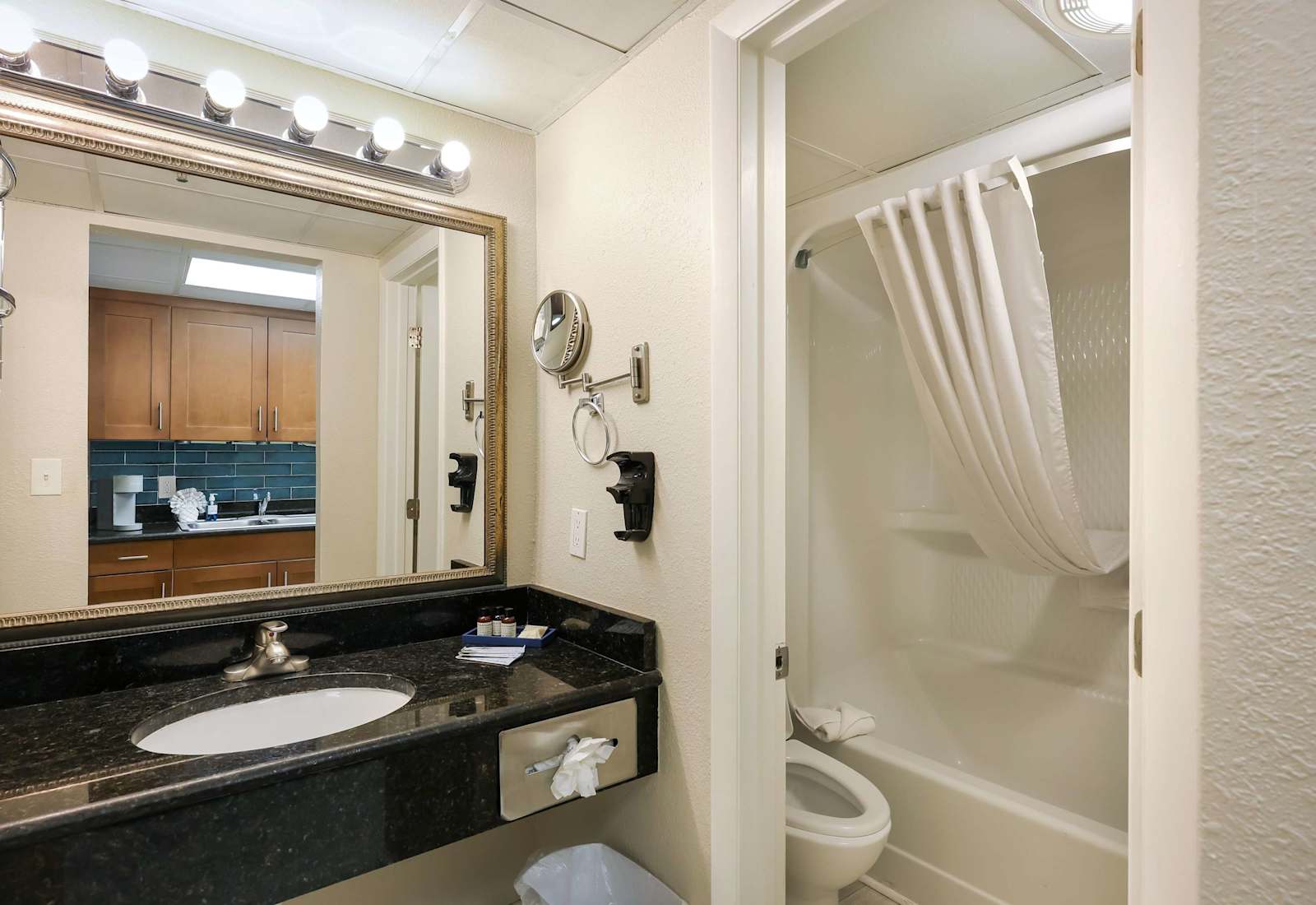 Freshen up in this bright and clean bathroom featuring granite countertops, a well-lit vanity, and a full shower and tub combo. Everything you need to relax and recharge after a day of beachside adventure.
