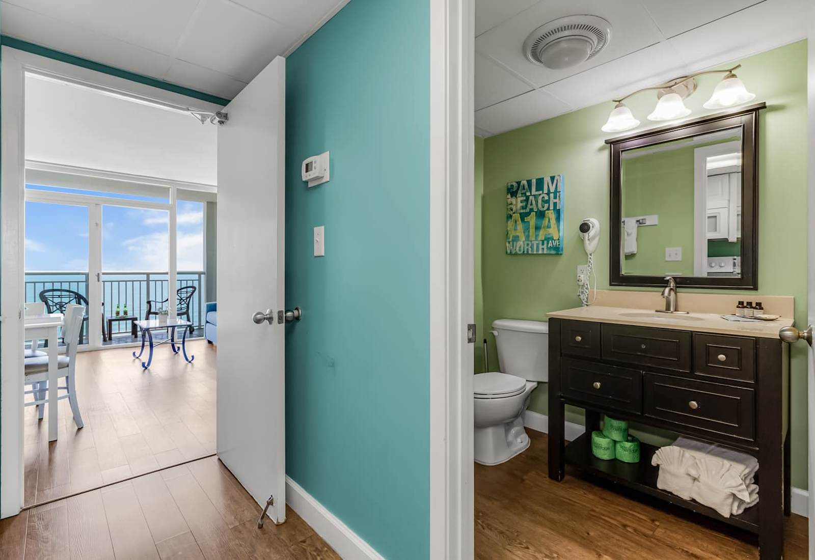 Bright and inviting bathroom with modern fixtures and a coastal flair! Just steps away, enjoy the open floor plan leading to breathtaking ocean views from the balcony. 
