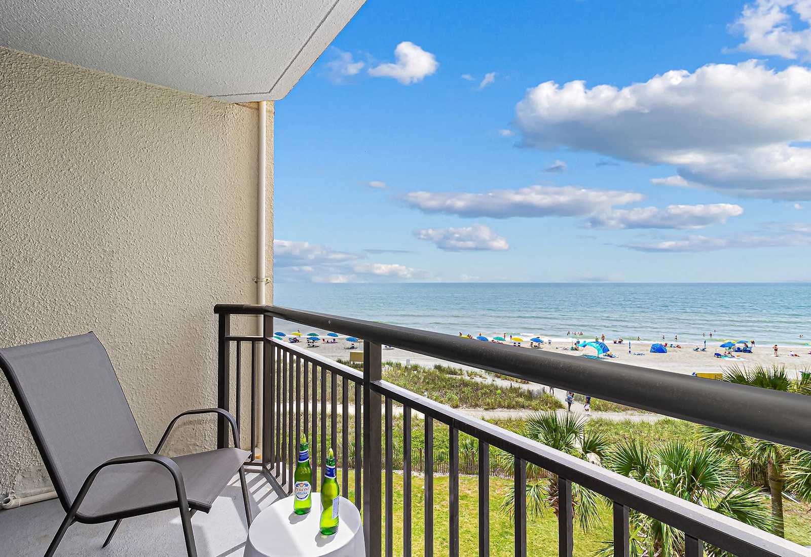 Take in panoramic views of the beach and resort pool from your balcony oasis. Whether you're planning adventures or enjoying a quiet moment, this view sets the perfect tone for your stay.
