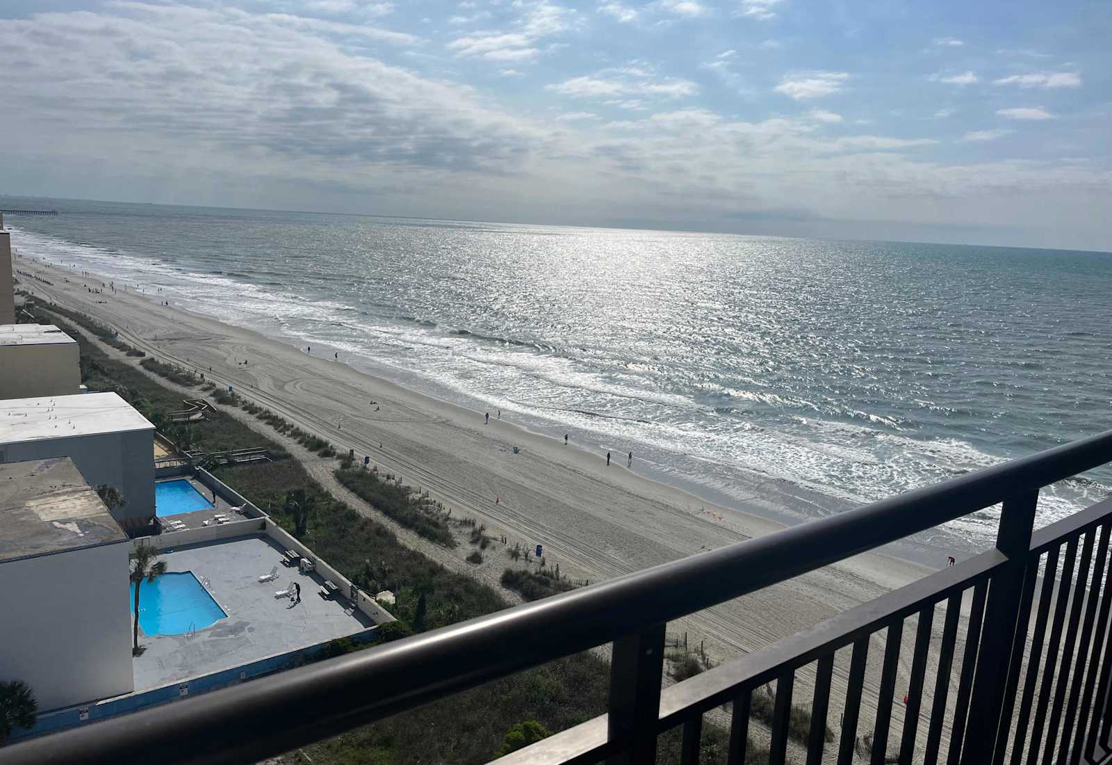 Breathtaking elevated ocean view from the balcony overlooking the beach and pool area