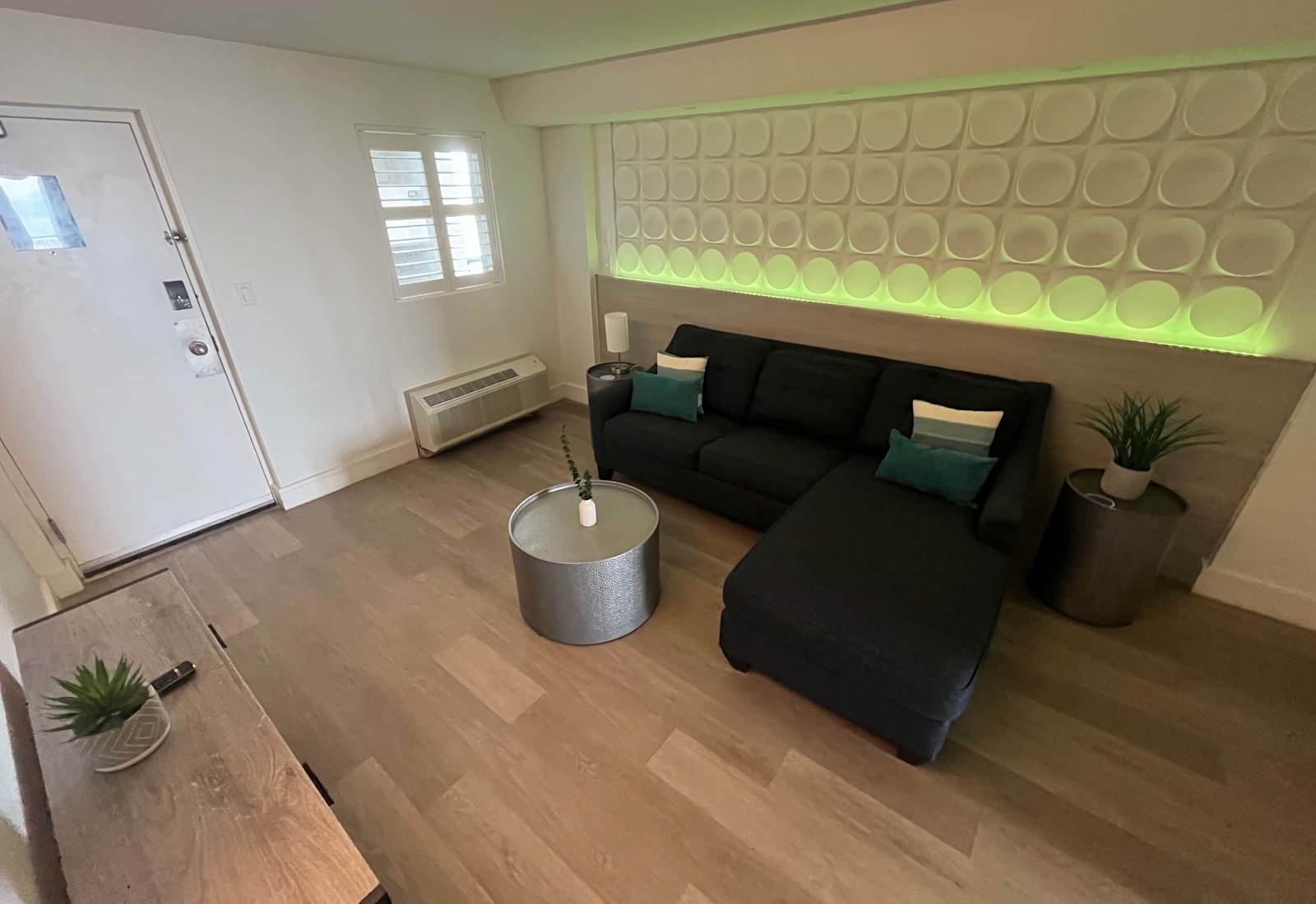 Unwind in this modern coastal living space, complete with a plush sectional sofa, soft ambient lighting, and elegant touches that create the perfect blend of comfort and style for your beachside retreat.