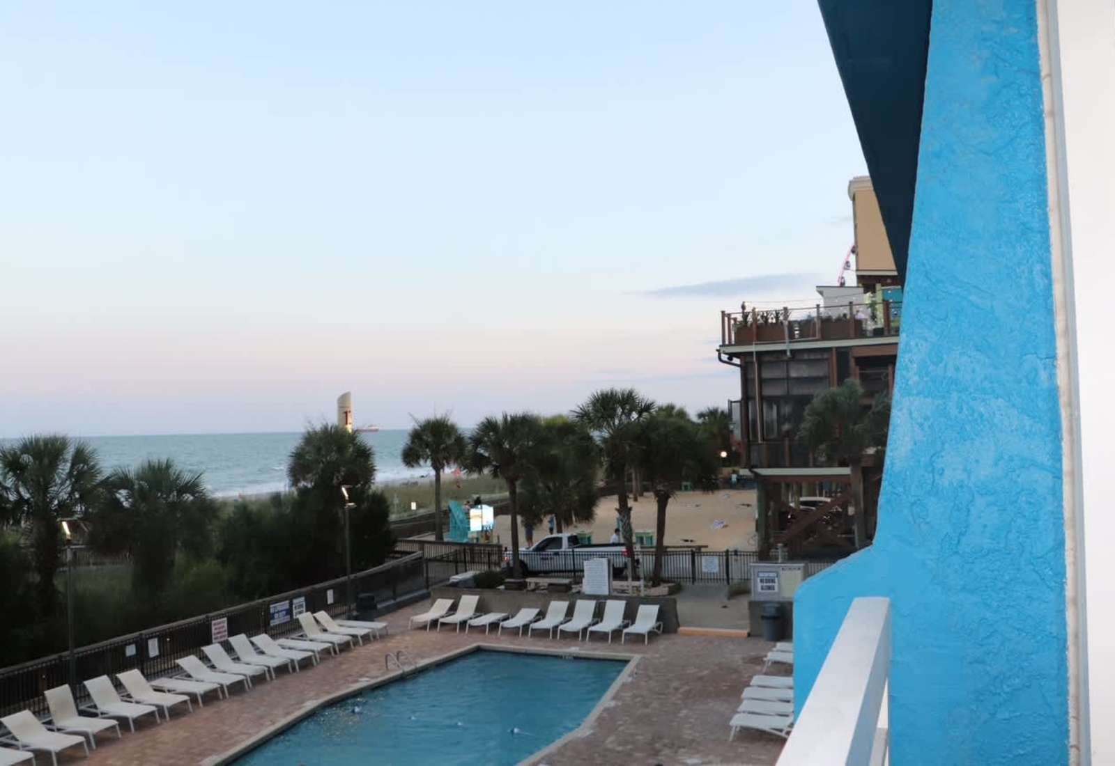 Enjoy panoramic views of the sparkling pool and the ocean just beyond from your Juliet balcony!