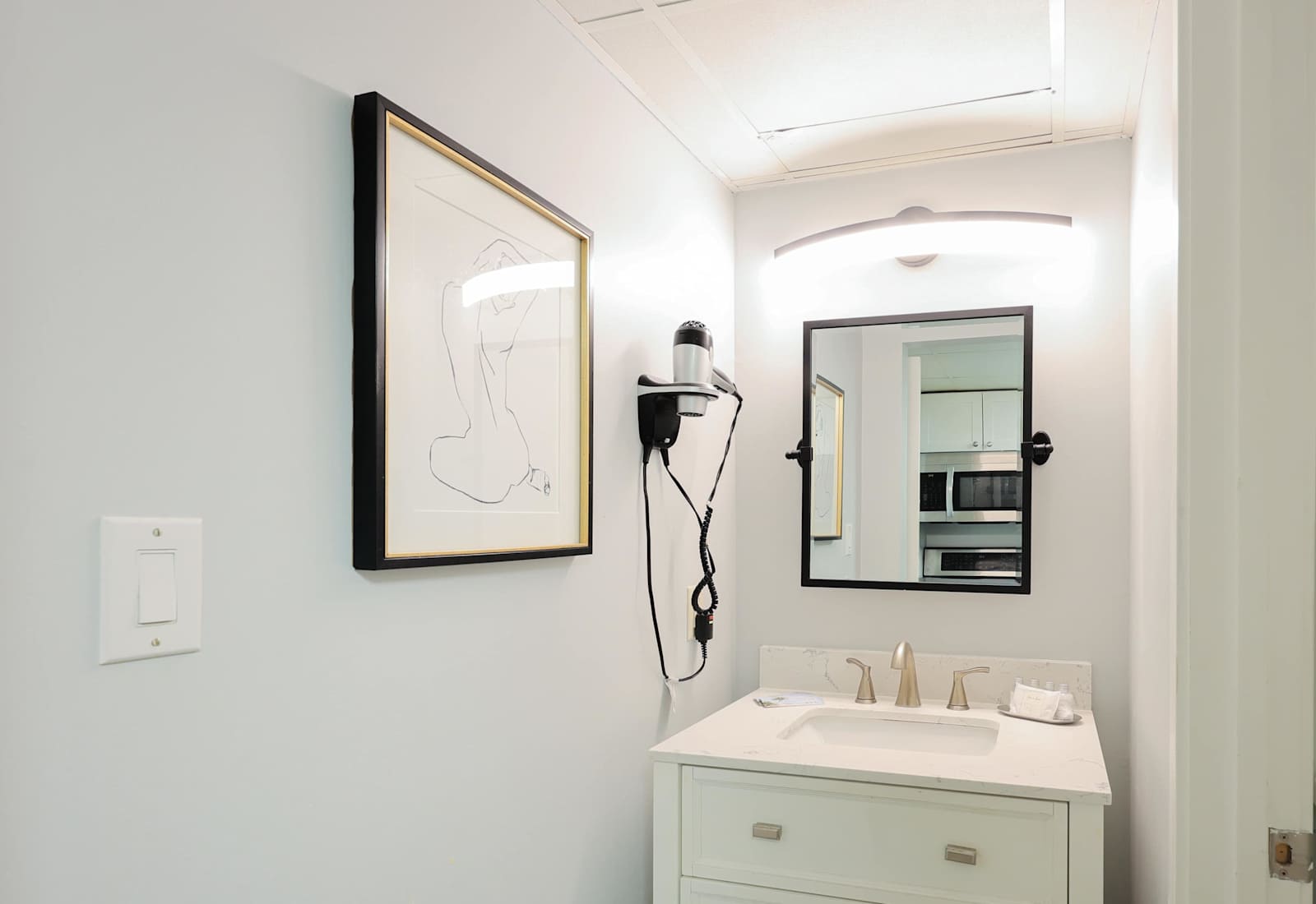 Get ready in style with this modern vanity space, complete with a well-lit mirror, sleek design, and built-in hairdryer. A clean and functional bathroom setup to keep you feeling refreshed during your Myrtle Beach stay!