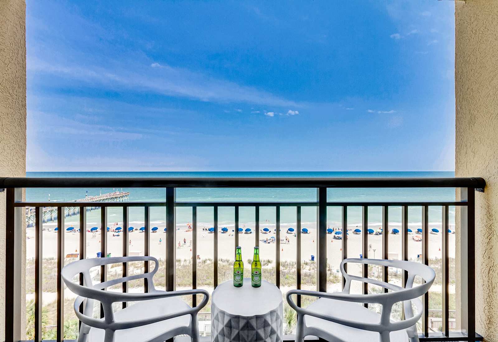 Enjoy stunning ocean views from your private balcony, complete with cozy seating to relax and take in the sights of the beach. Perfect for morning coffee or sunset evenings!