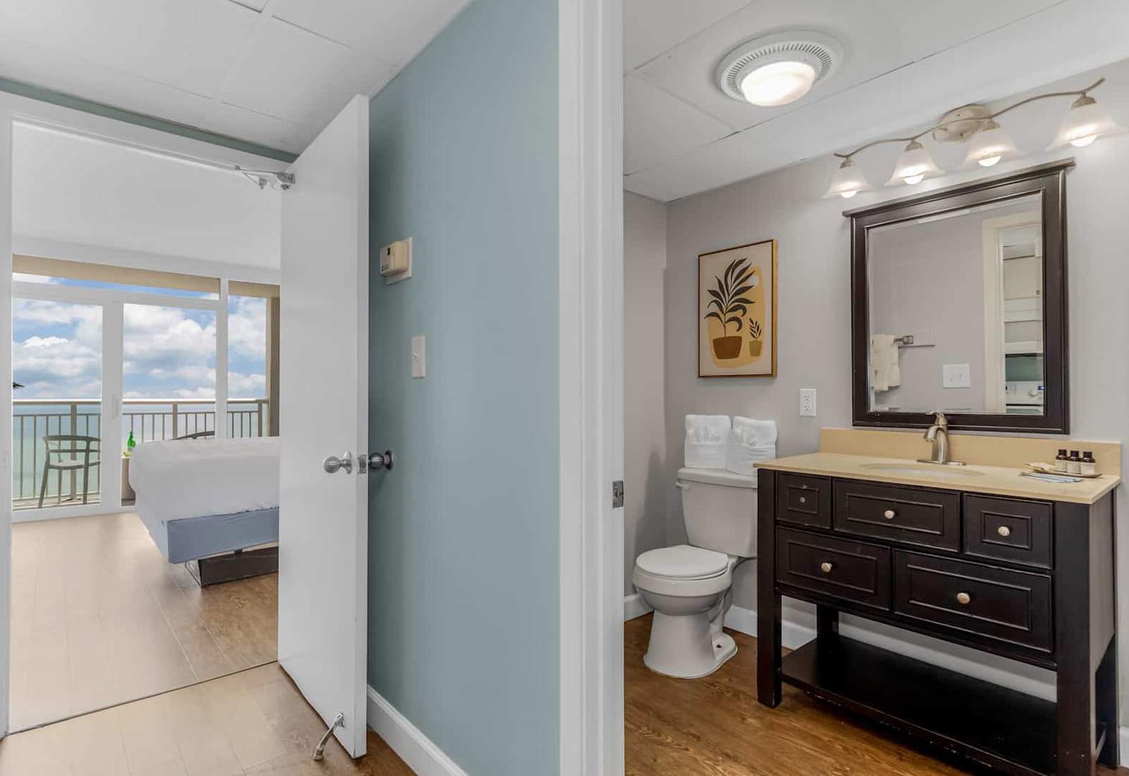 Conveniently designed ensuite with a stylish vanity and a calming ambiance. Enjoy the seamless connection to your cozy bedroom with stunning ocean views just steps away.