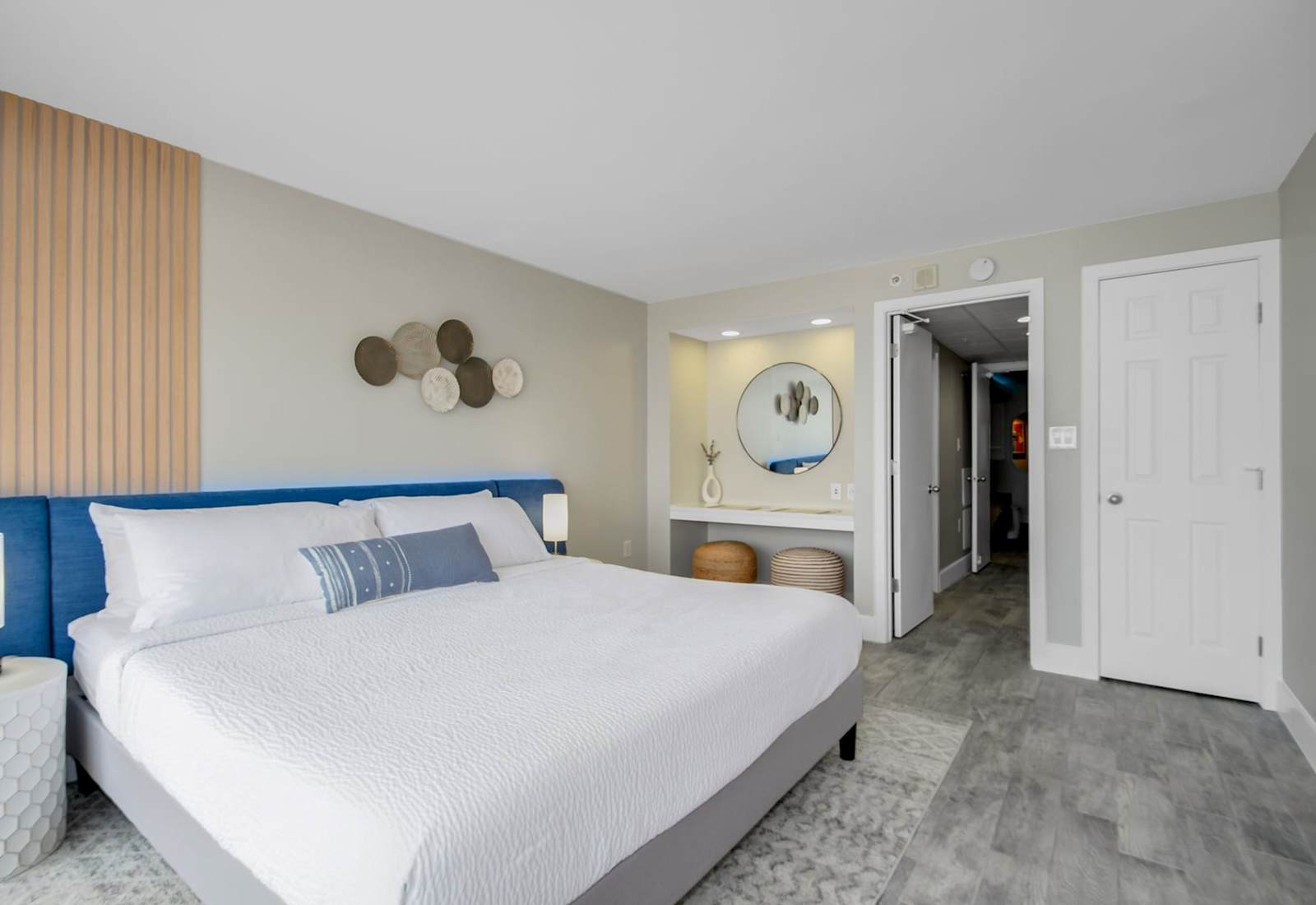 Retreat to this elegant bedroom featuring a luxurious king bed, chic decor, and a cozy vanity nook. Thoughtfully designed with modern accents and soft lighting, this space offers a perfect blend of style and comfort for a restful night’s sleep.