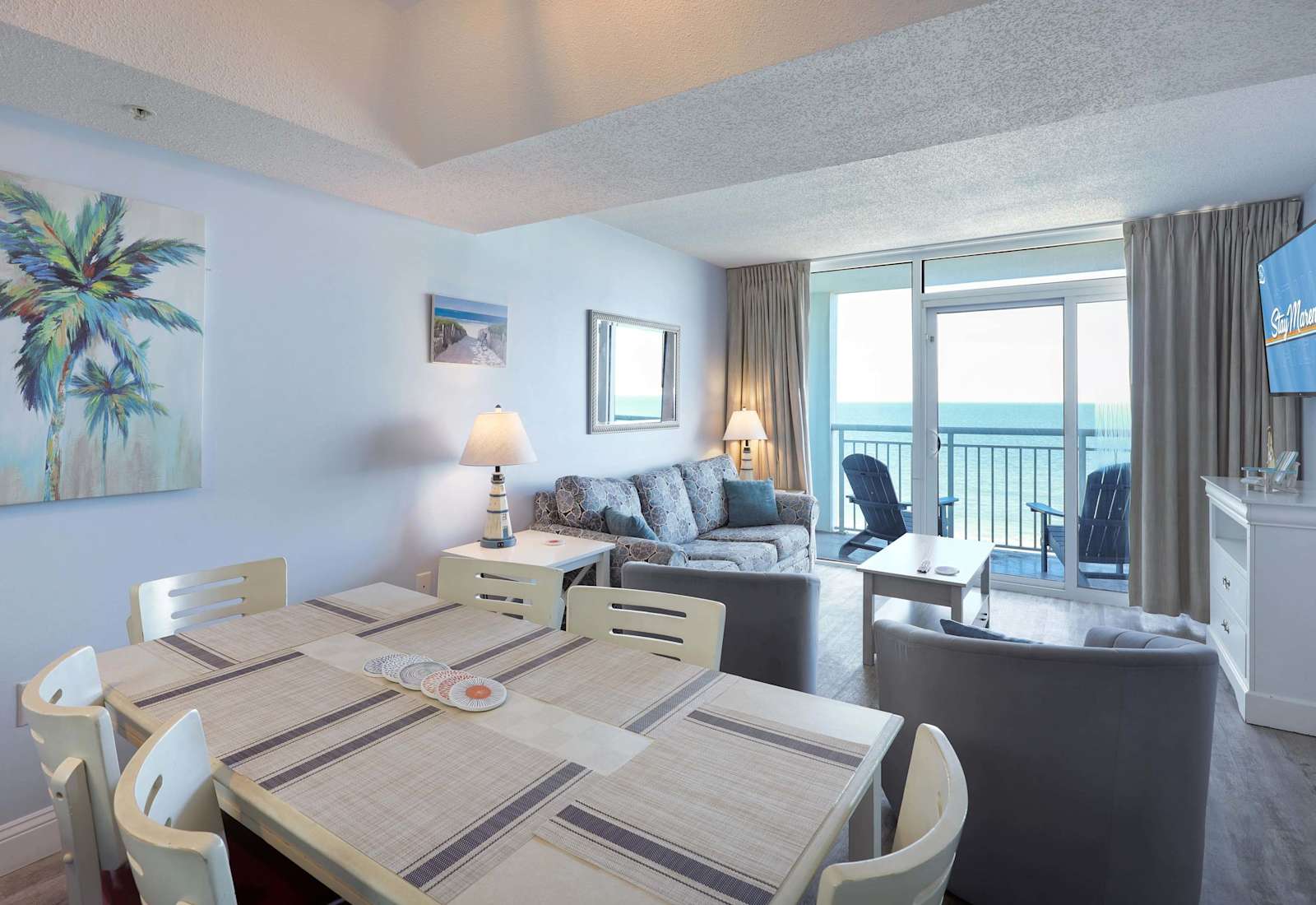 Relax in coastal comfort! This bright, beach-themed open-concept living and dining space is perfect for family gatherings, game nights, and making memories just steps from the ocean. Spacious, stylish, and fully equipped for your seaside escape!