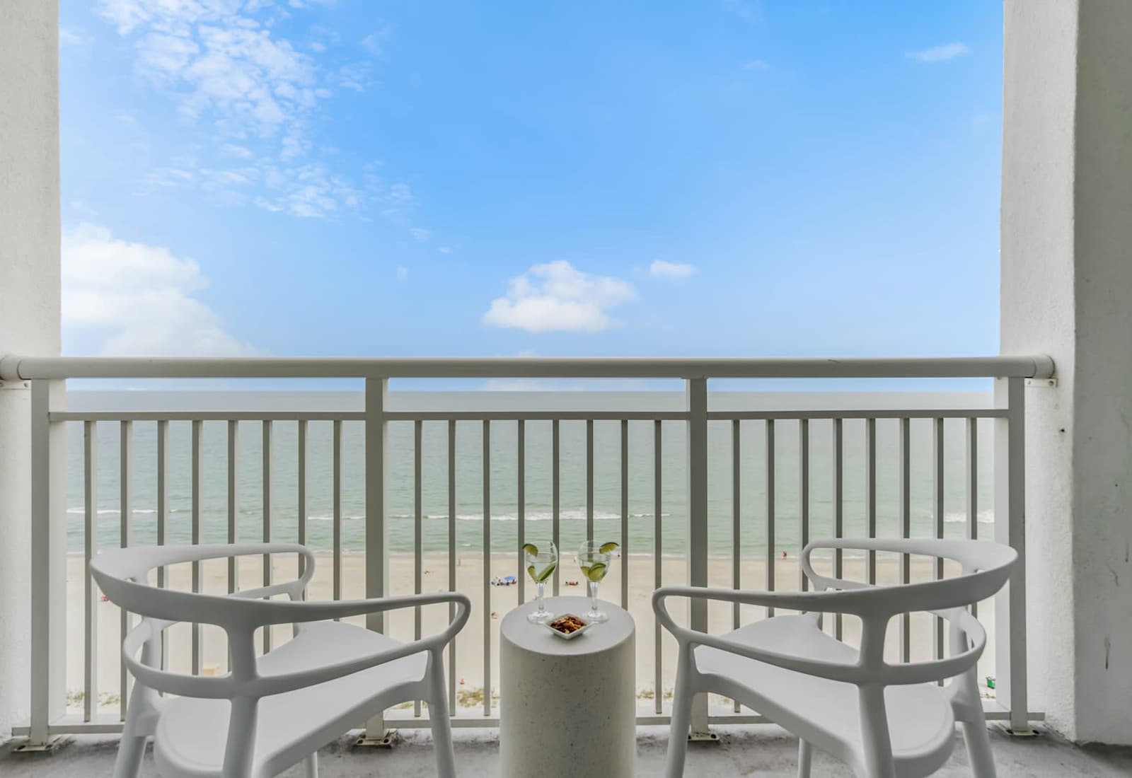Sip your favorite drink while soaking in breathtaking ocean views from this private balcony. With cozy seating and serene beach vibes, it's the perfect spot to relax and enjoy the coastal breeze.