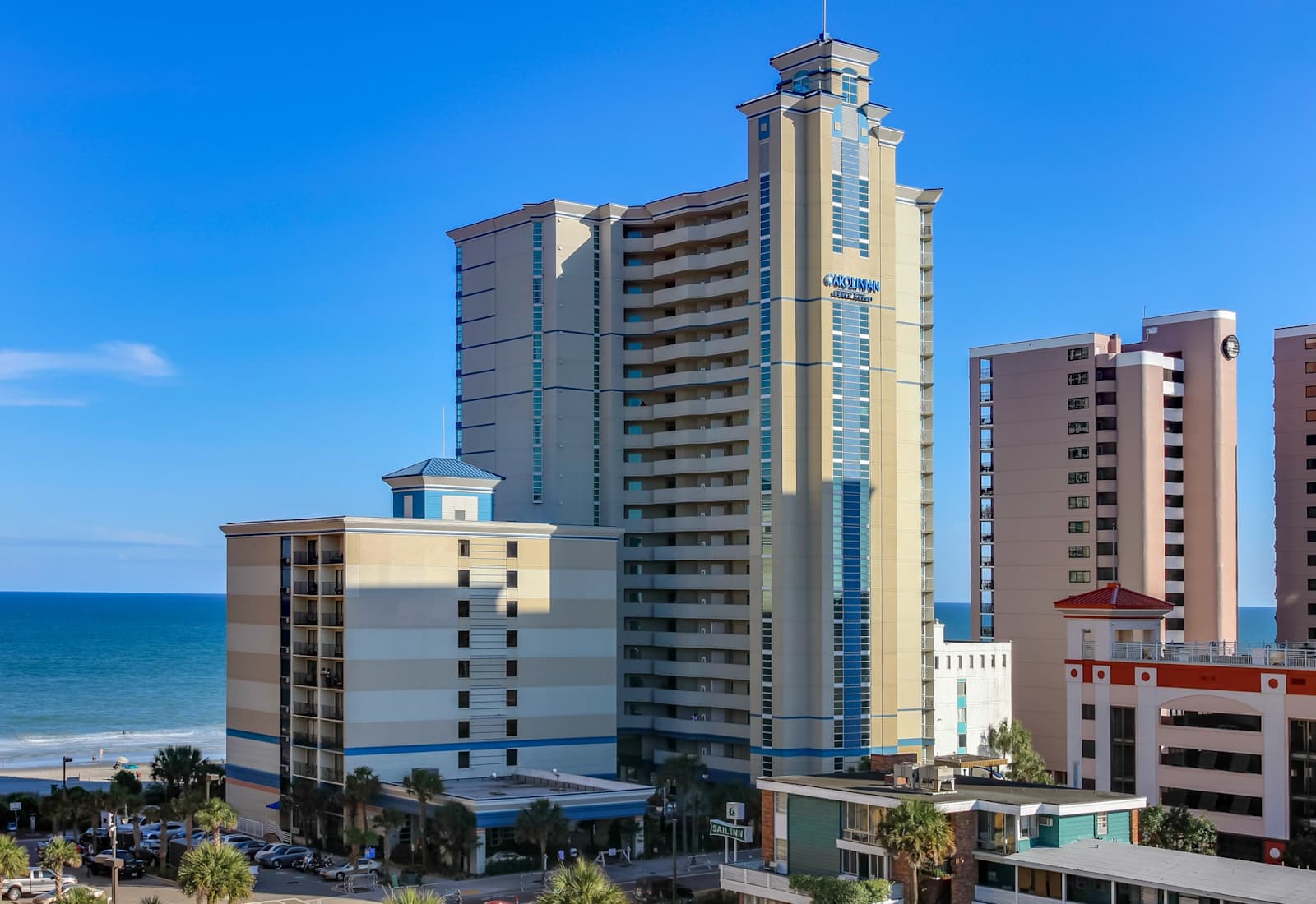 Exterior view of the oceanfront resort building, set along the beach with easy access to coastal scenery and nearby high-rise views.
