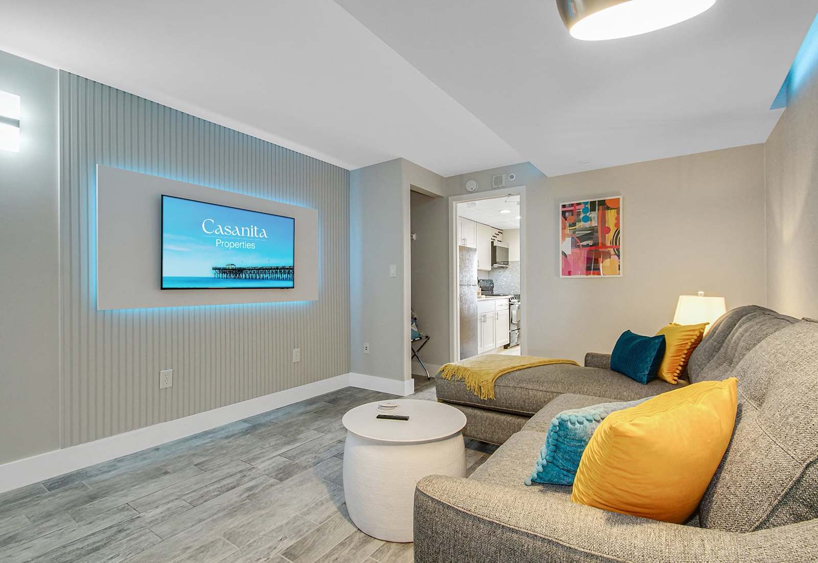 Relax in this cozy, living area featuring a plush sectional, accent lighting, and a Smart TV for entertainment. The soothing decor and comfortable seating make it an ideal spot to unwind after a day of exploring.