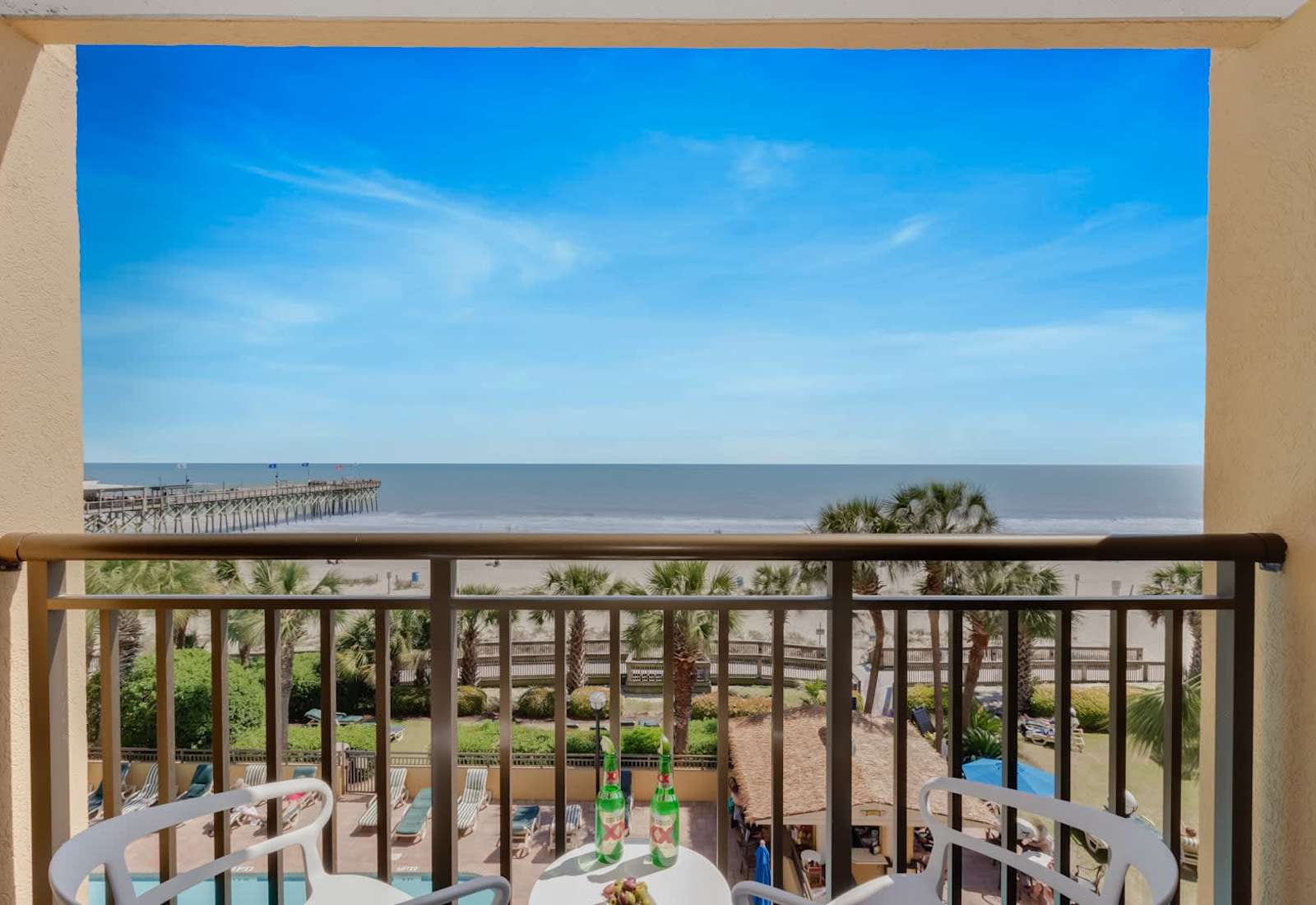Enjoy stunning ocean views from your private balcony, complete with cozy seating to relax and take in the sights of the beach. Perfect for morning coffee or sunset evenings!