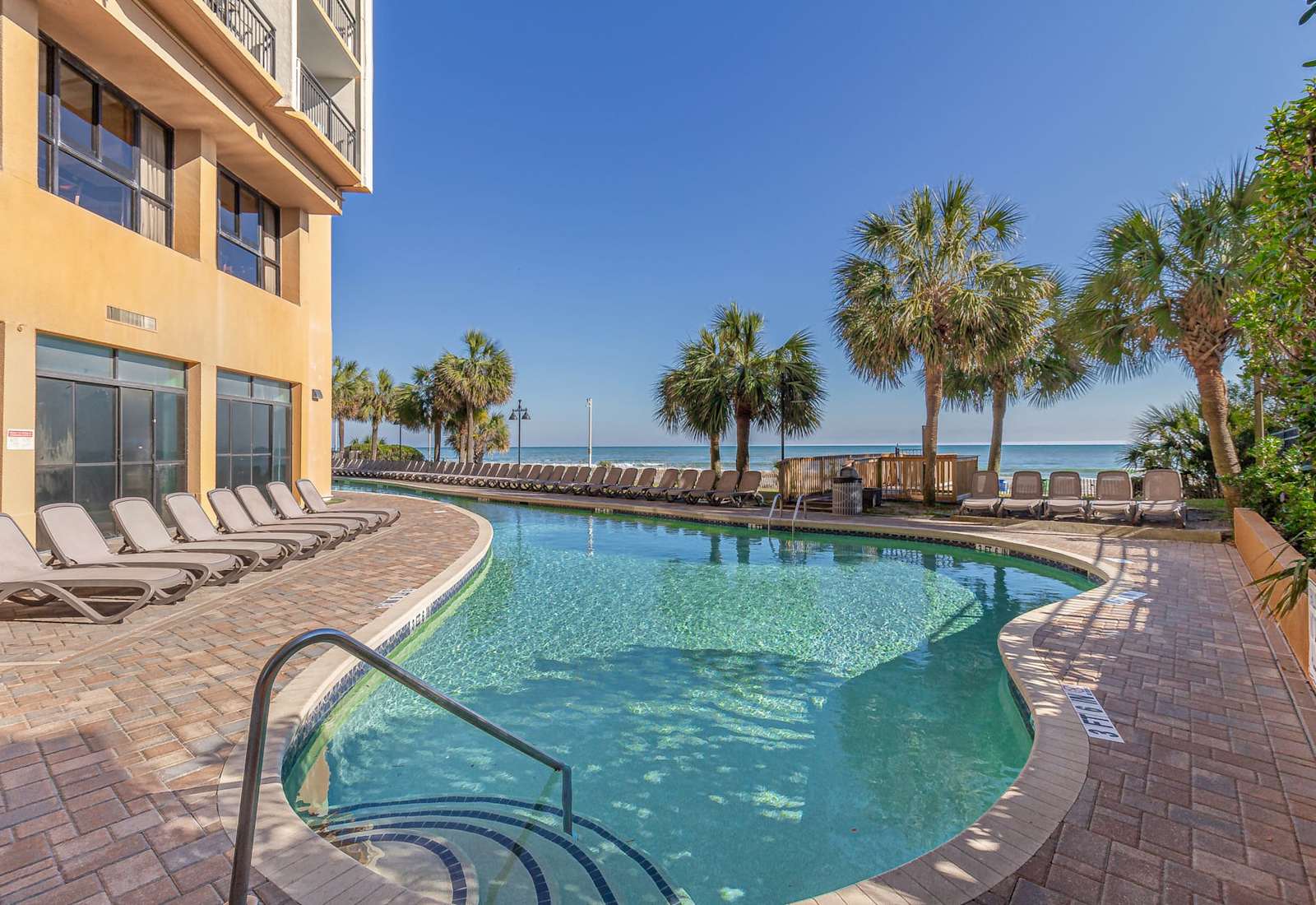 Enjoy the best of both worlds with this inviting pool just steps from the beach. Start your day with a refreshing dip or end it with a sunset swim under the coastal sky.